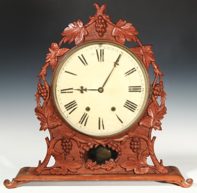 A 19TH CENTURY BLACK FOREST CARVED MANTEL CLOCK