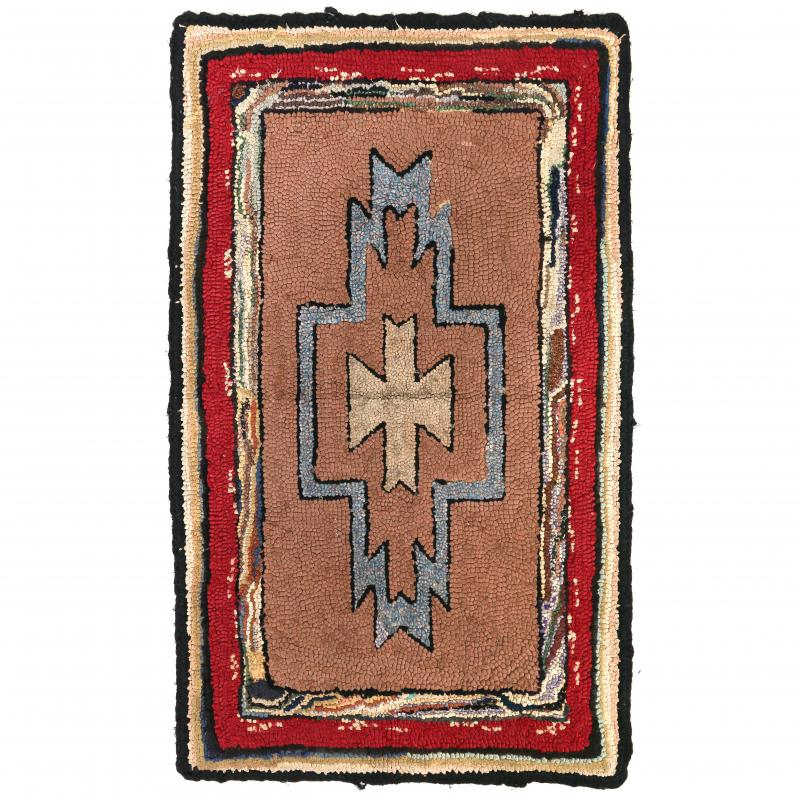 A VINTAGE HOOKED RUG IN THE STYLE OF A NAVAJO RUG 