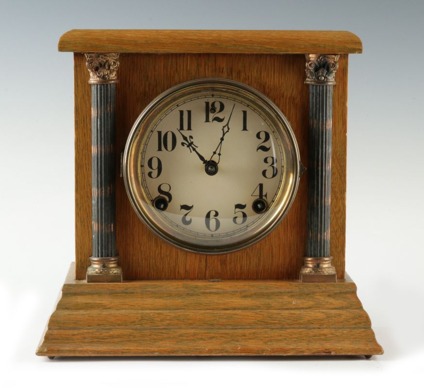 A SMALL SESSIONS CABINET CLOCK 