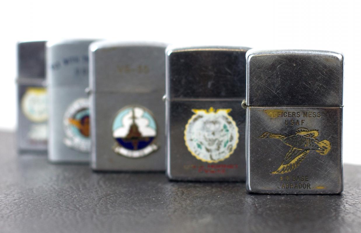 A GROUP OF TWELVE MILITARY THEME ZIPPO LIGHTERS