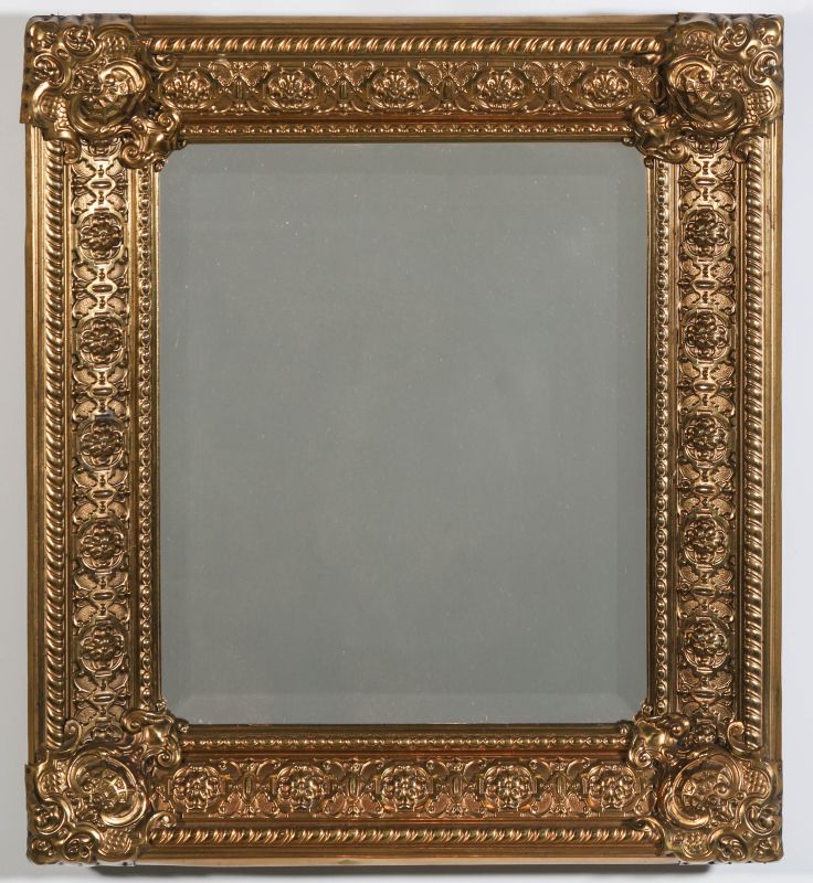 AN EARLY 20TH C MIRROR WITH EMBOSSED BRASS FRAME