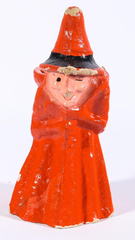 A FIGURAL WITCH PRESSED PAPER CANDY CONTAINER