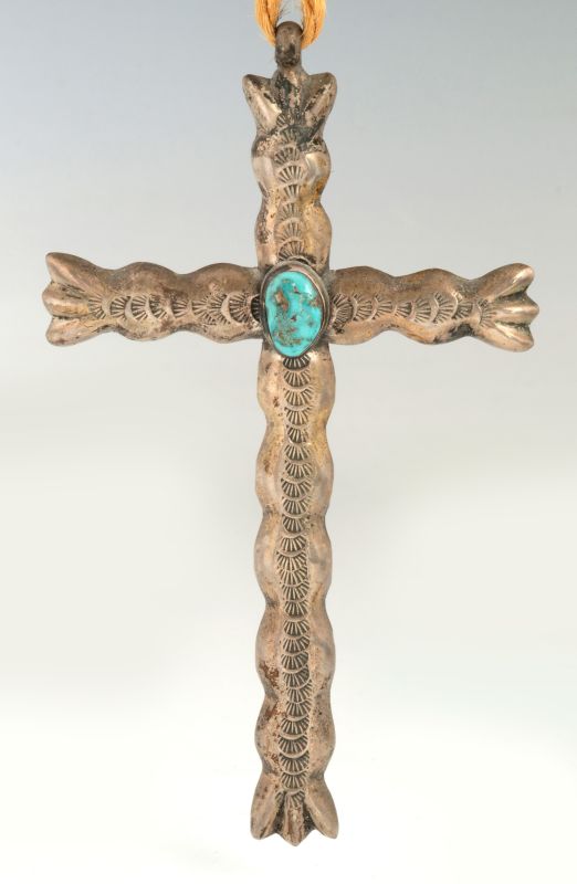 A NAVAJO SAND CAST STERLING AND TURQUOISE CROSS