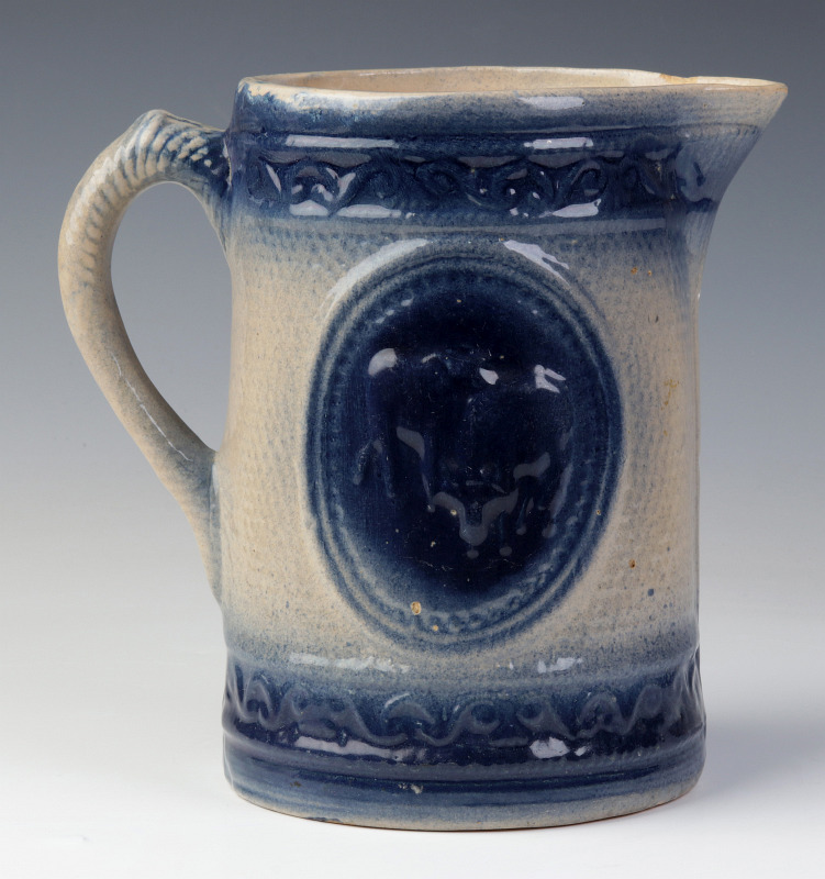 A BLUE AND WHITE STONEWARE PITCHER WITH COWS
