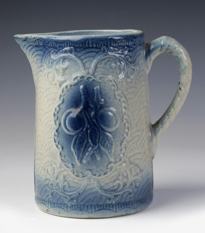 A BLUE AND WHITE STONEWARE PITCHER WITH CHERRIES
