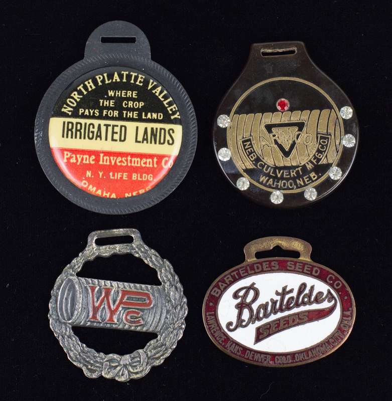 FOUR VARIOUS ENAMELED AND OTHER ADVERTISING FOBS