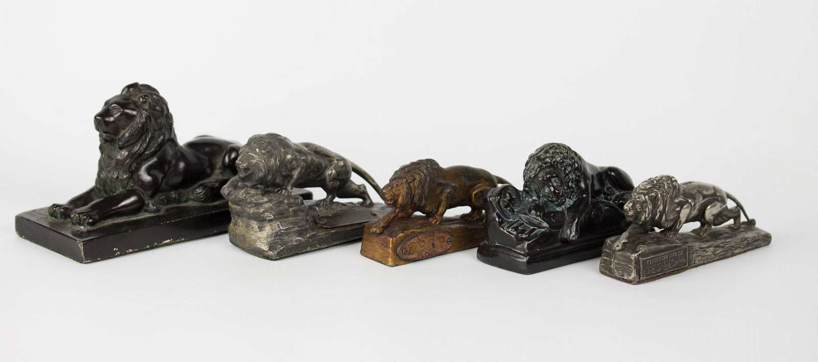 FIVE FIGURAL LION ADVERTISING PAPERWEIGHTS
