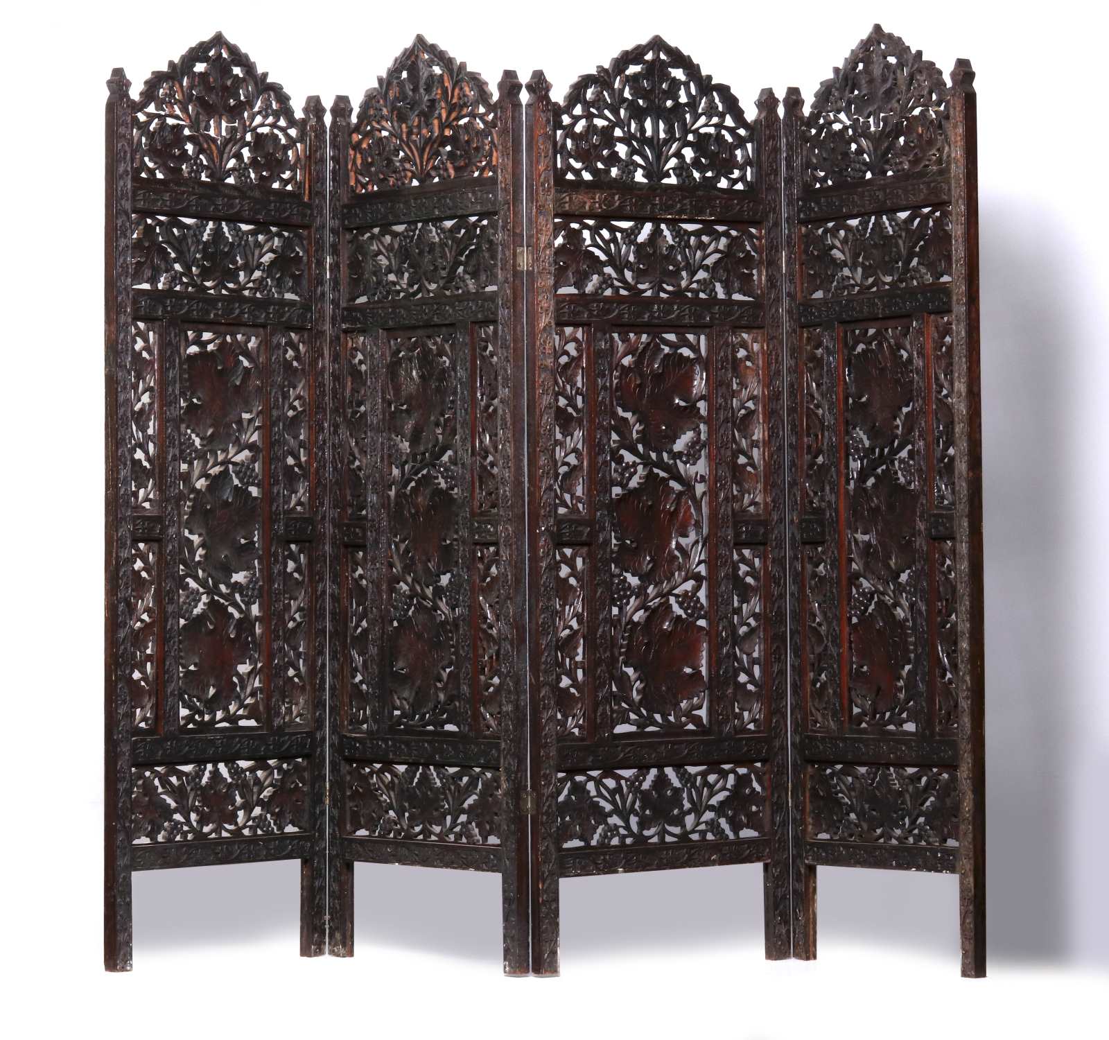 A HIGHLY CARVED INDIAN ROSEWOOD TABLE SCREEN
