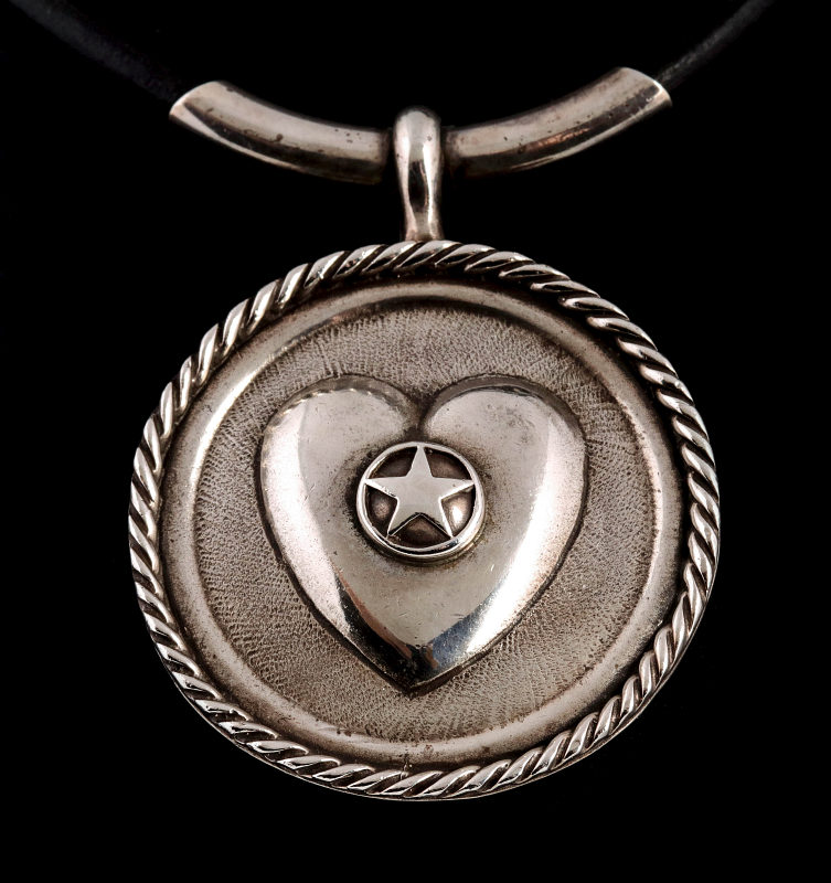 AN ARNOLD GOLDSTEIN STERLING DOUBLE-SIDED PENDANT
