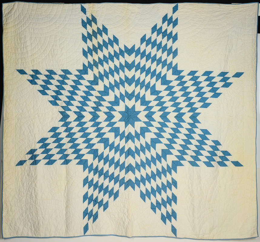 A VINTAGE BLUE AND WHITE 'TEXAS STAR' QUILT