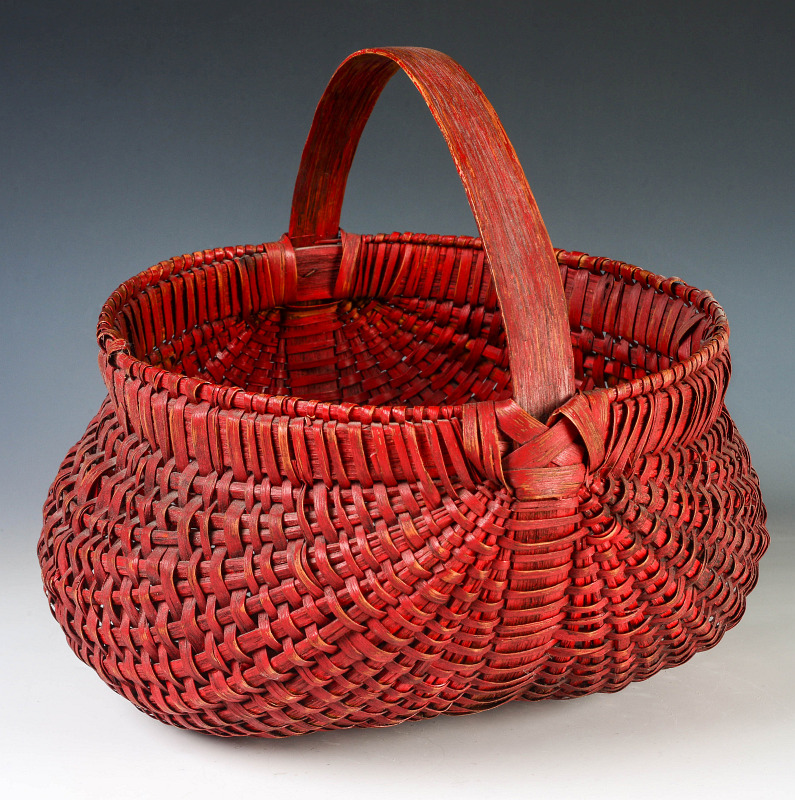A 19TH C. AMERICAN BUTTOCKS BASKET WITH RED PAINT