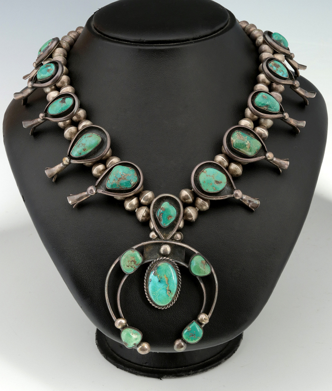 A STERLING AND TURQUOISE SQUASH BLOSSOM NECKLACE