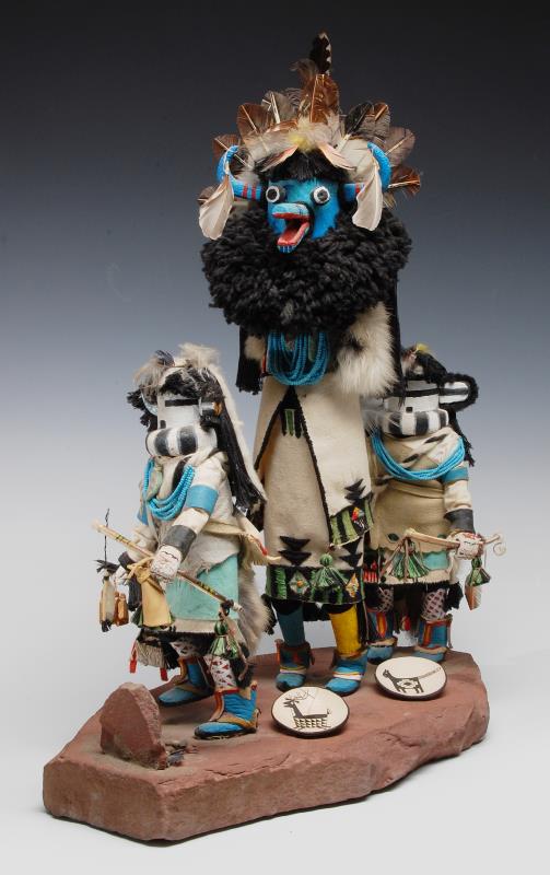 A GROUPING OF HOPI KACHINAS WITH AHOTE ON ROCK BAS