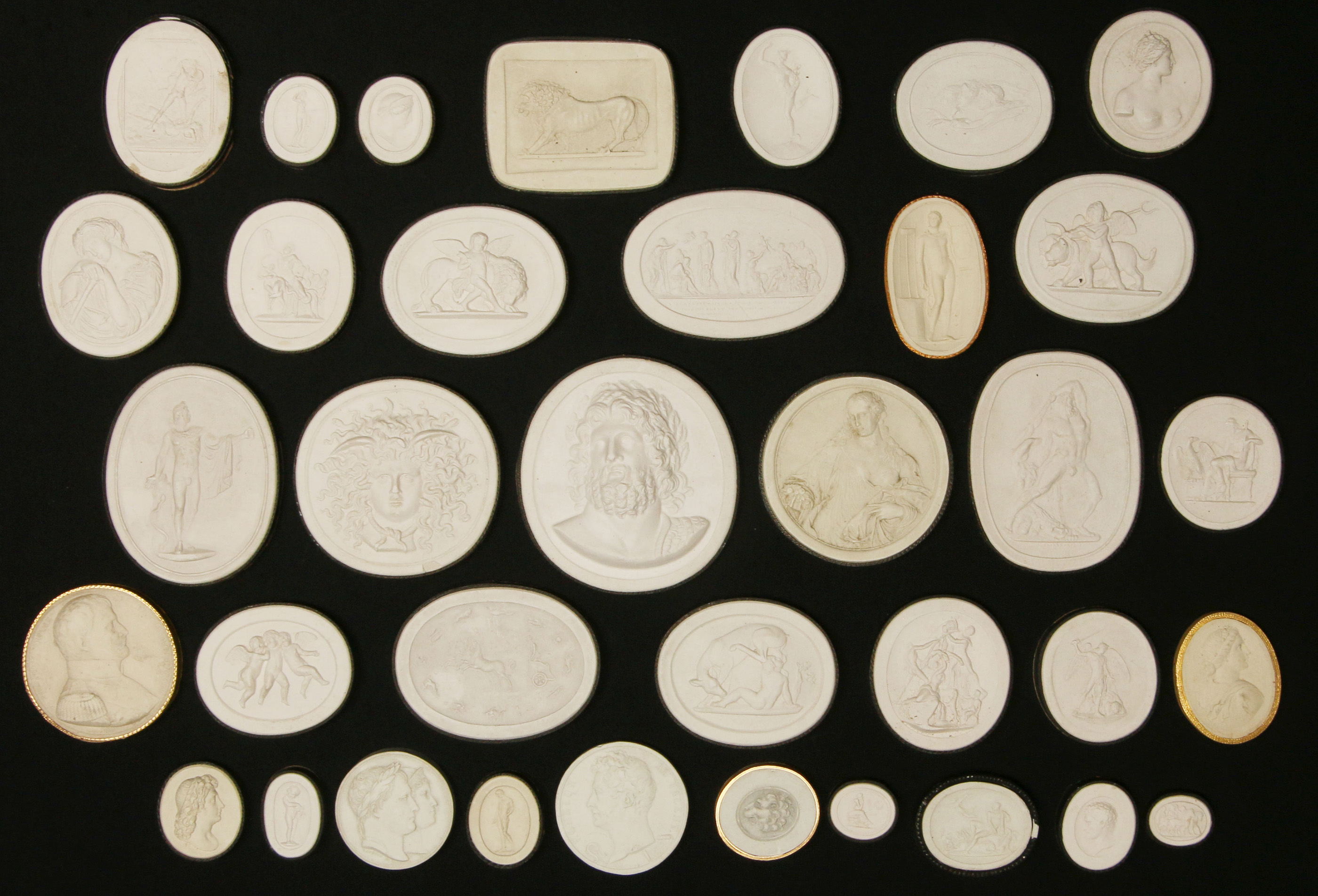 A COLLECTION OF EARLY 20TH C PLASTER INTAGLIOS