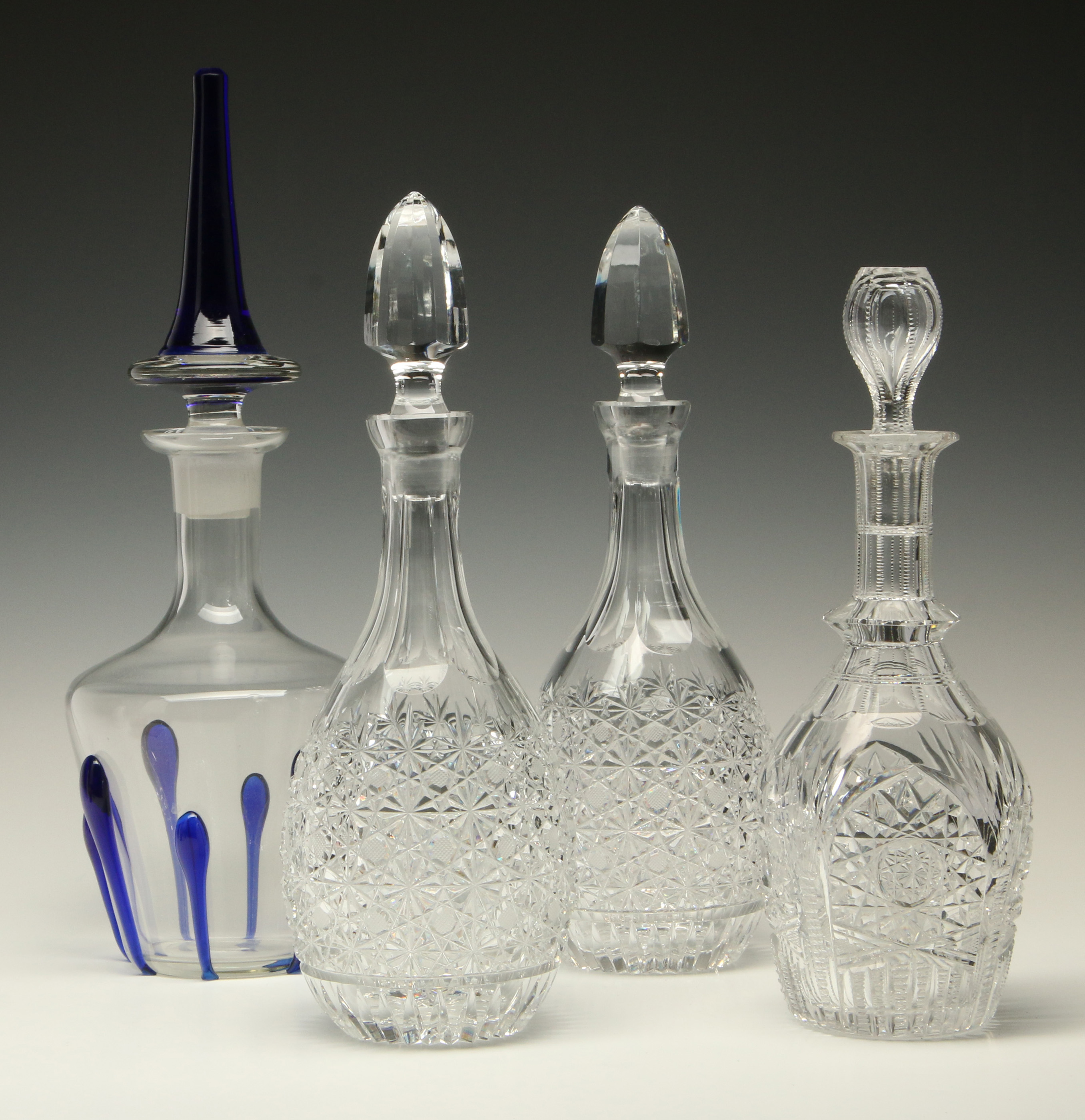 A COLLECTION OF FOUR GOOD CRYSTAL DECANTERS