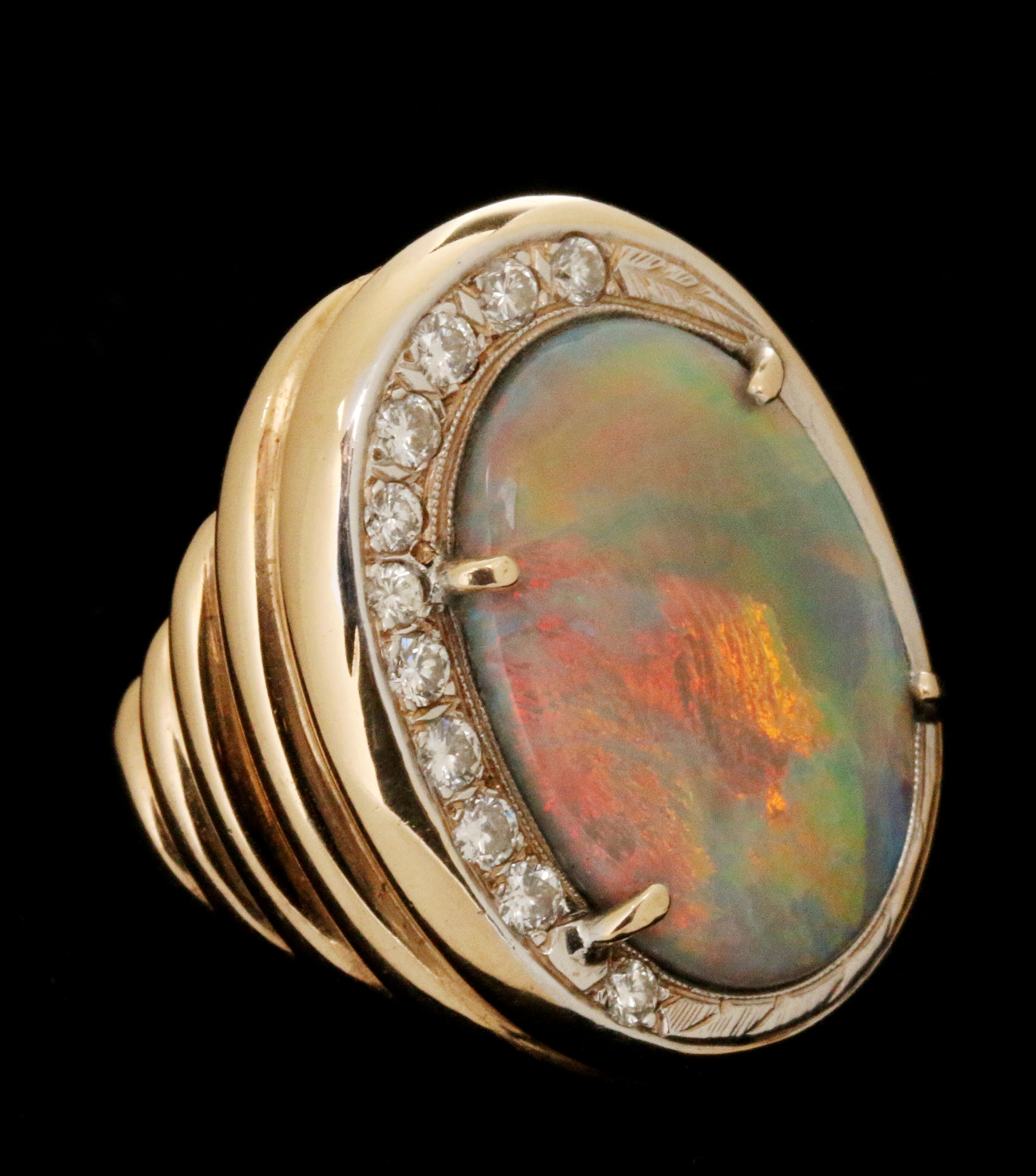A LADIES FIERY OPAL RING WITH 1/3 CARAT TW OF DIAM