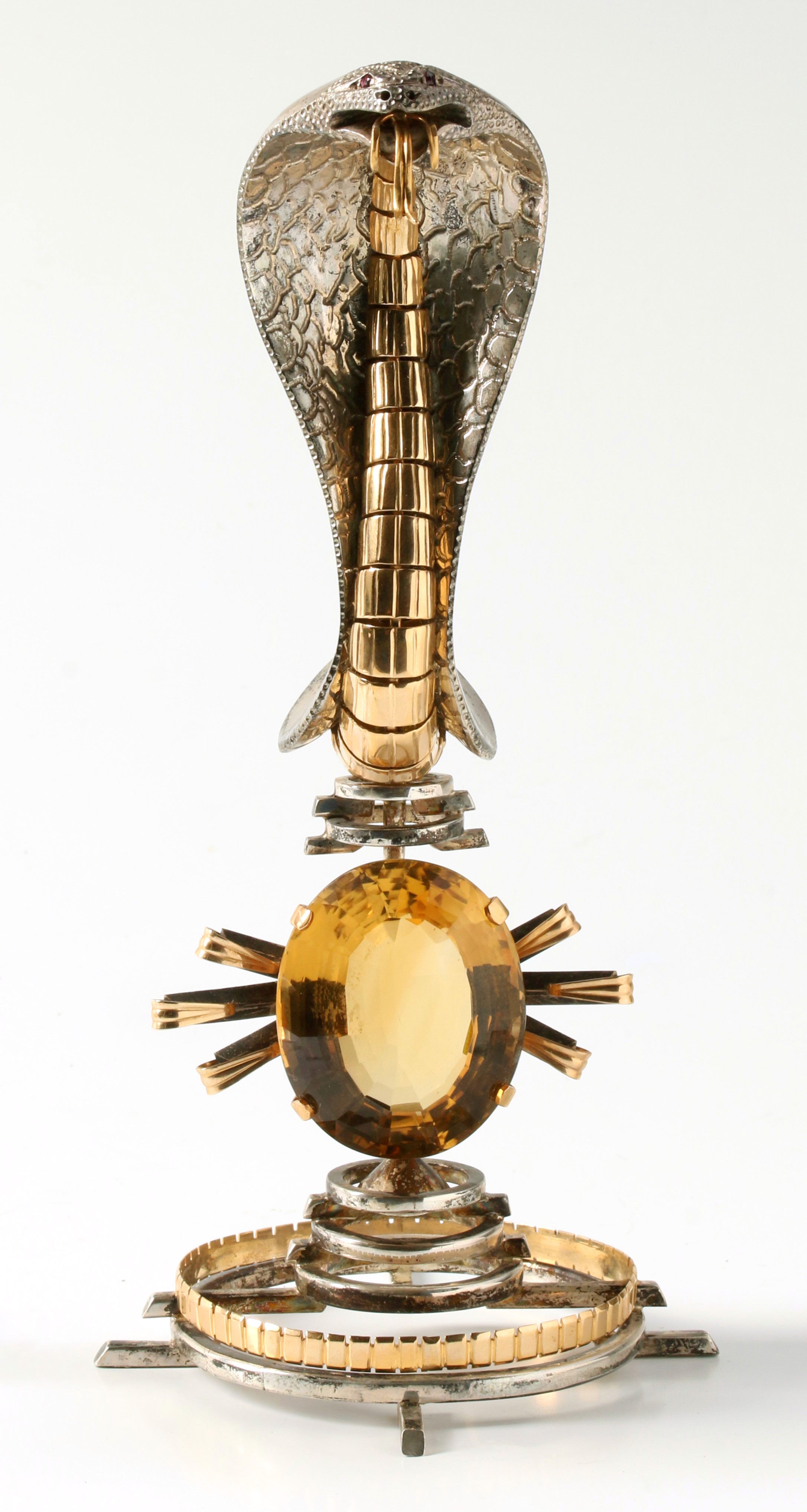 A SILVER AND GOLD COBRA OVERLOOKING A CITRINE SUN
