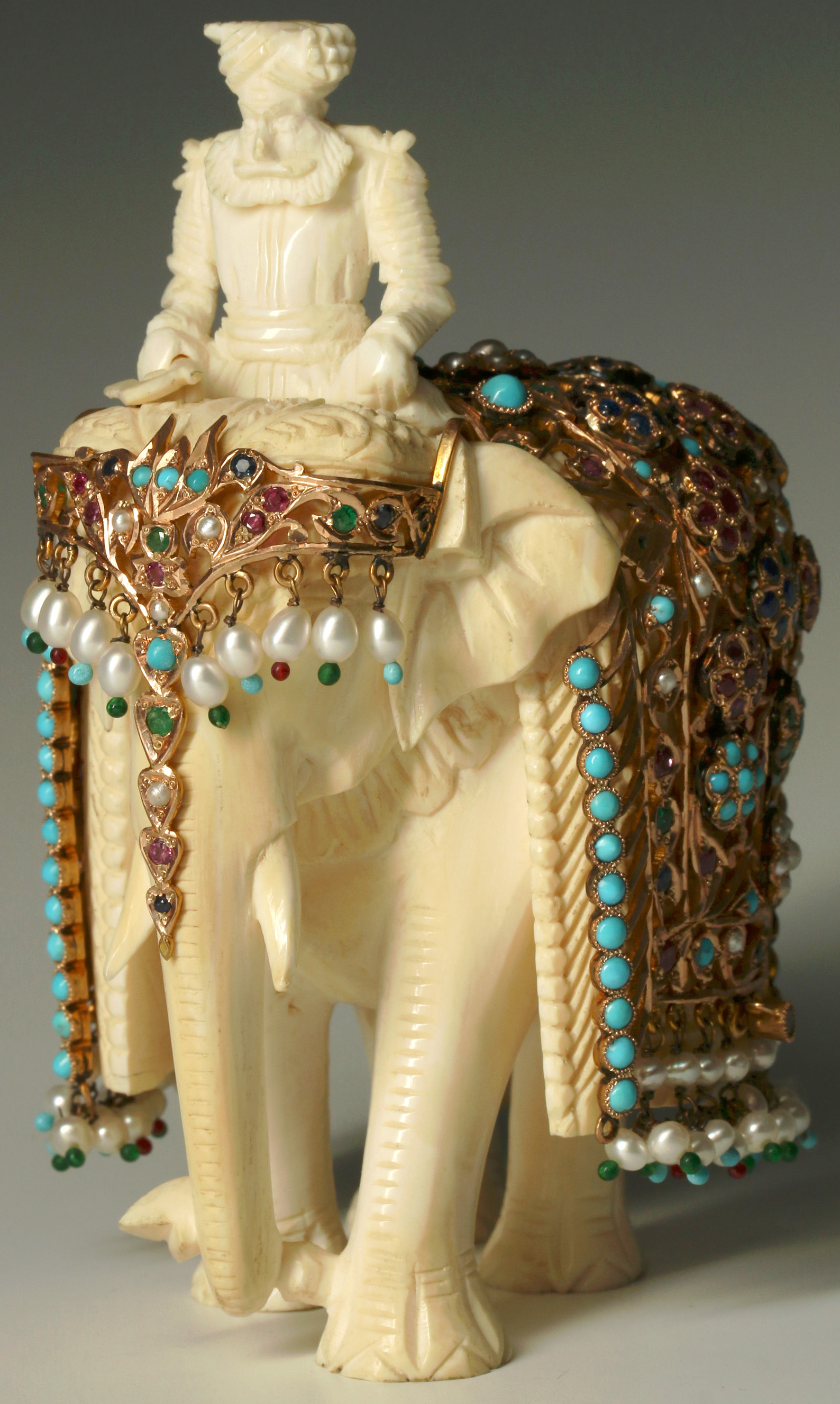 A SRI LANKAN GOLD AND GEMSTONE MOUNTED ELEPHANT