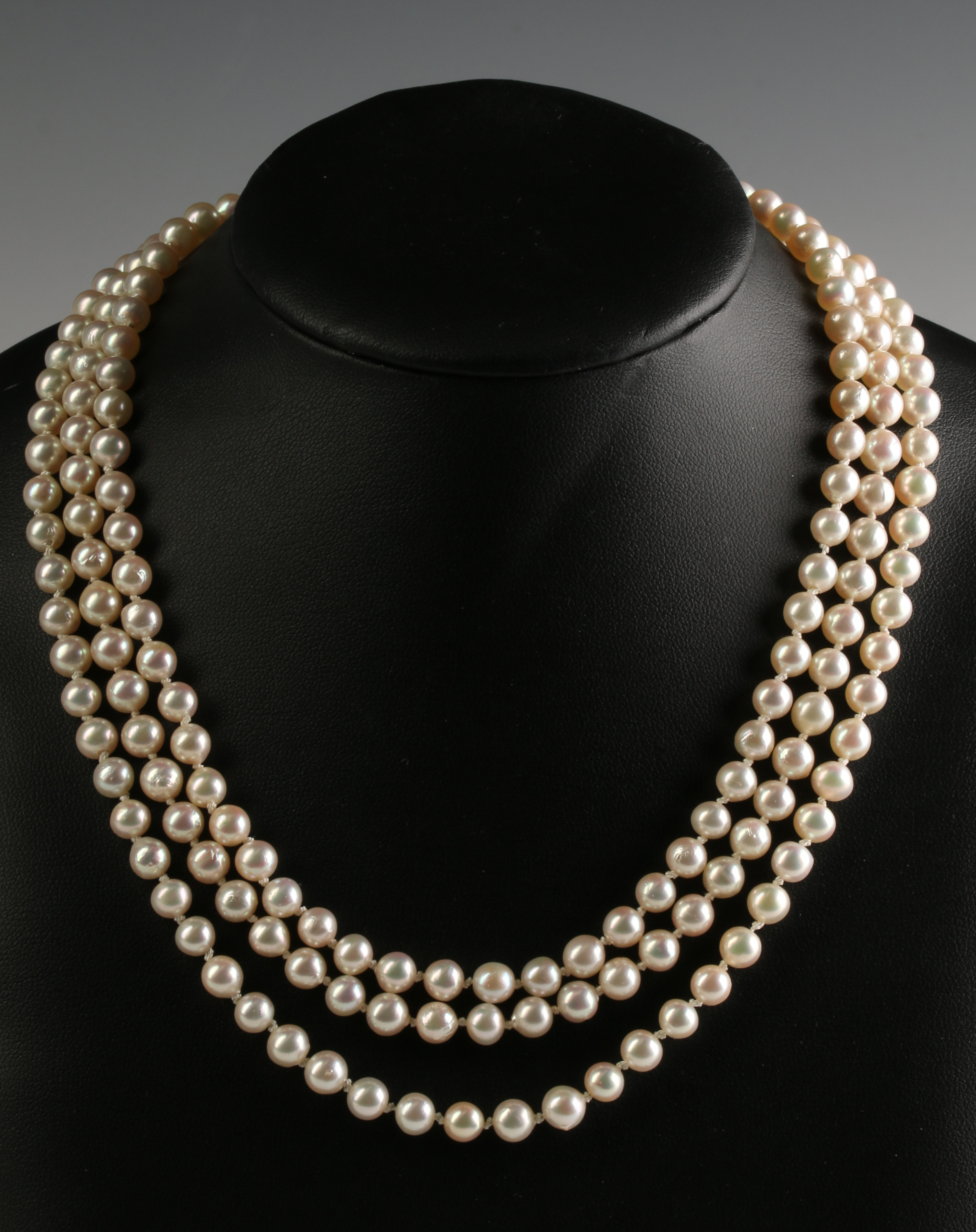 A TRIPLE STRAND OF CULTURED PEARLS WITH GEMSTONE C