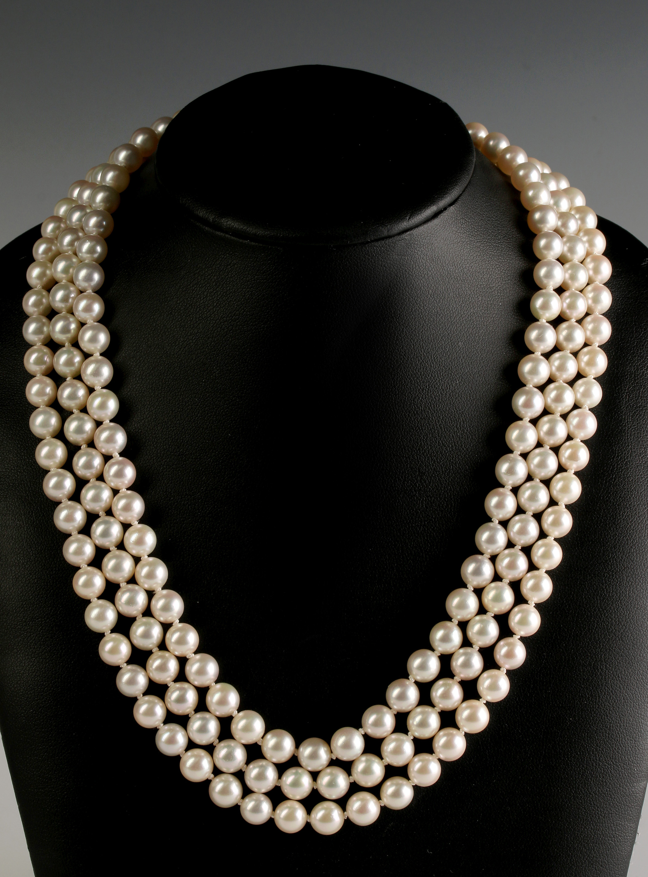 A FOUR STRAND PEARL NECKLACE WITH DIAMOND CLASP