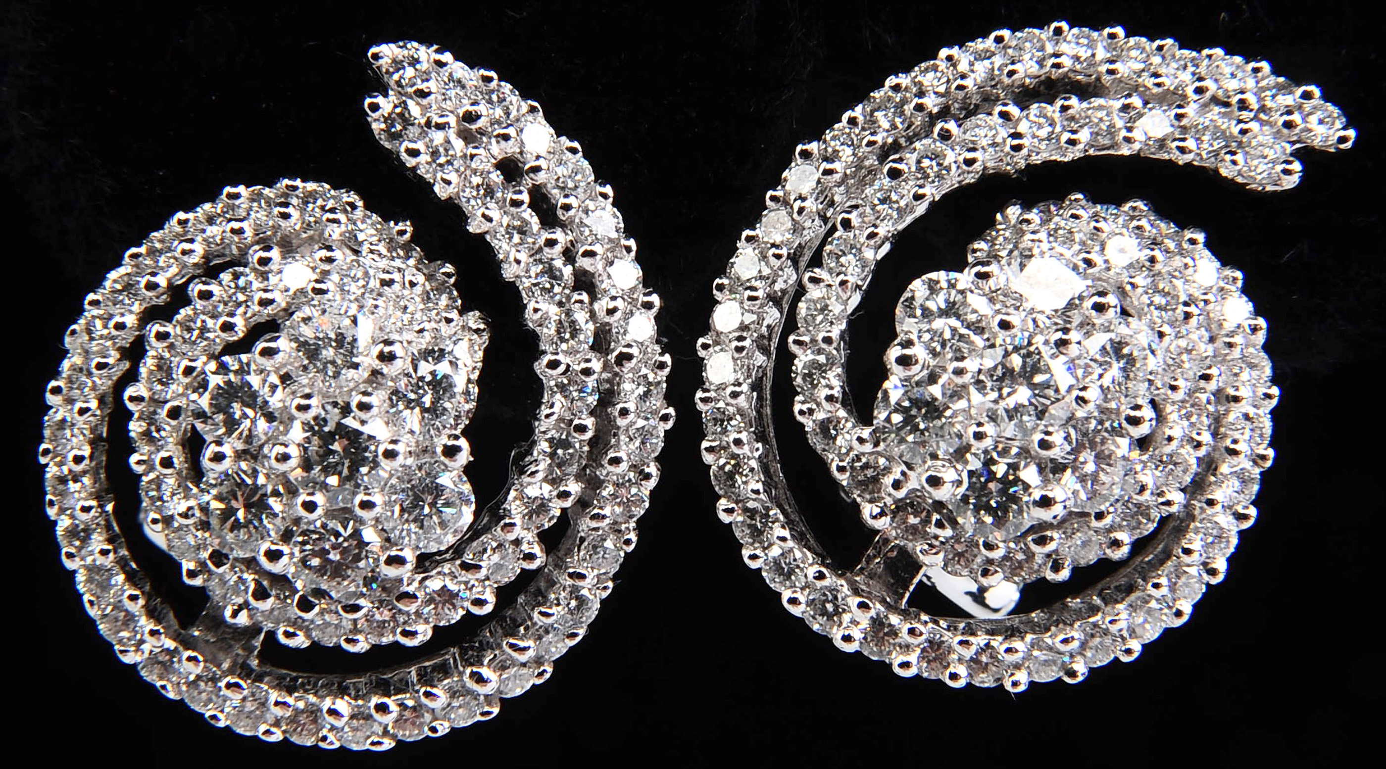 A PAIR 14K GOLD CLUSTER AND SWIRL DIAMOND EARRINGS