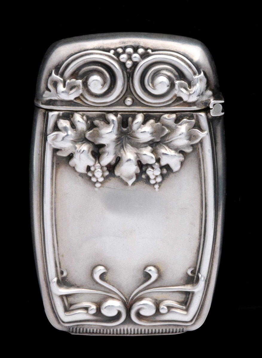 AN ANTIQUE STERLING MATCH SAFE WITH VINEYARD THEME
