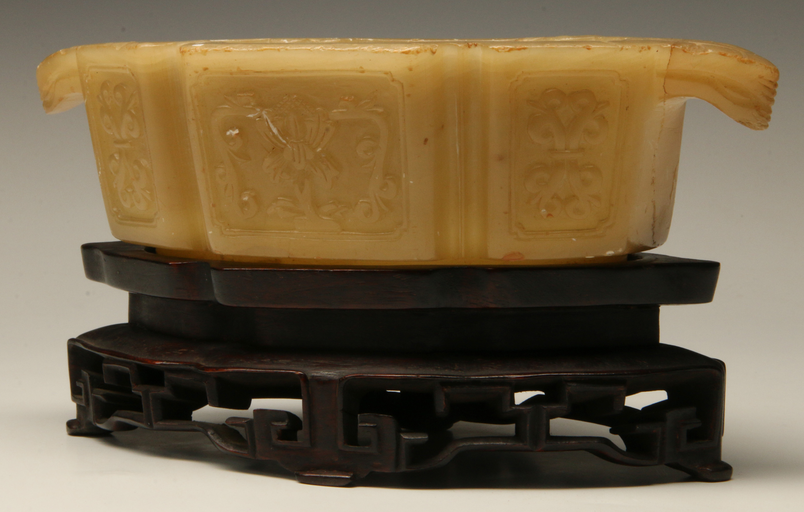 A CHINESE LOZENGE SHAPED JADE CUP ON STAND