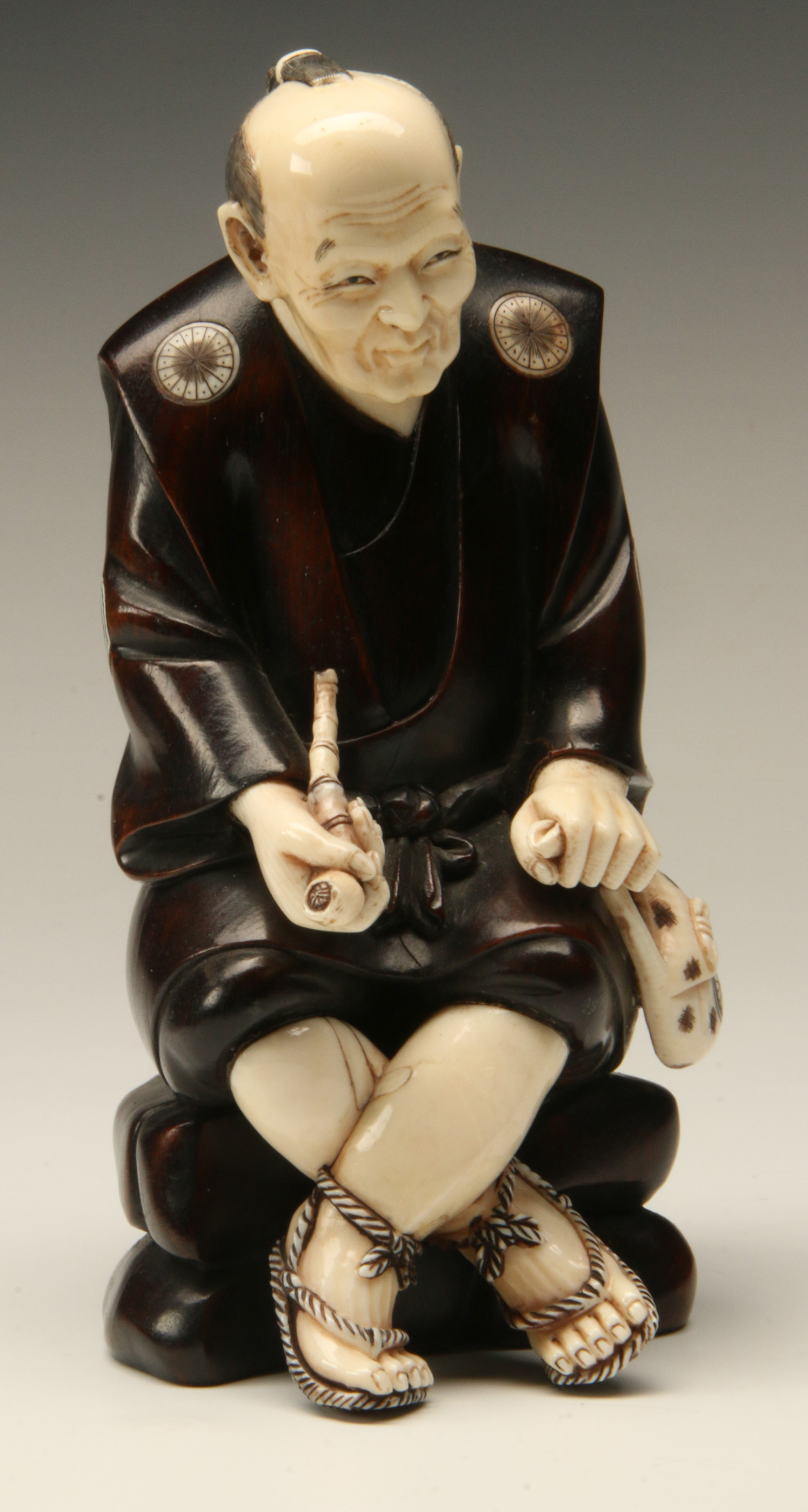 A MEIJI PERIOD JAPANESE IVORY AND HARDWOOD CARVING