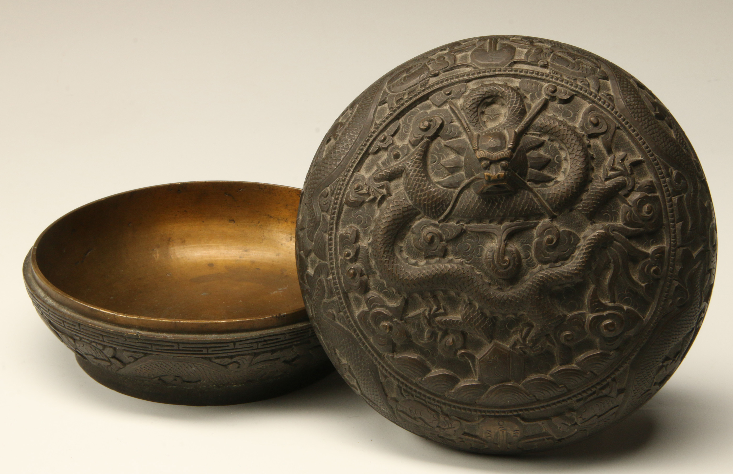 A CHINESE RELIEF MOLDED CIRCULAR BOX WITH DRAGON