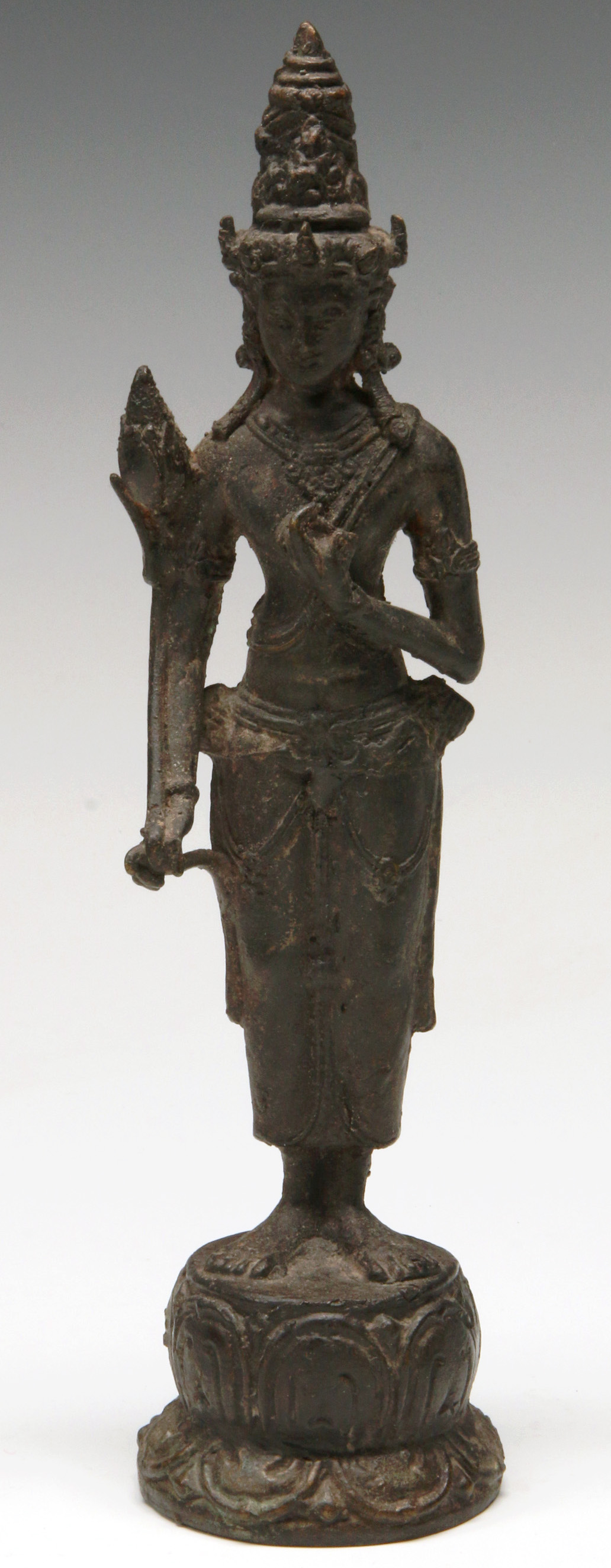A STANDING BRONZE FIGURE OF GUANYIN ON LOTUS BASE