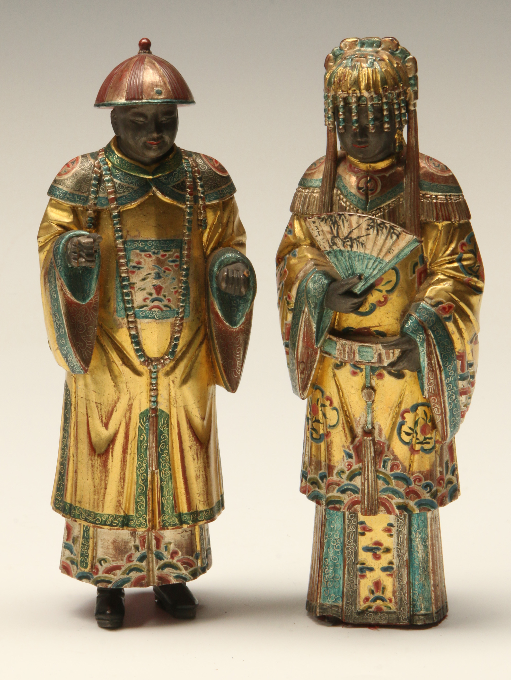 A PAIR OF CHINESE POLYCHROME AND GILTWOOD CARVINGS