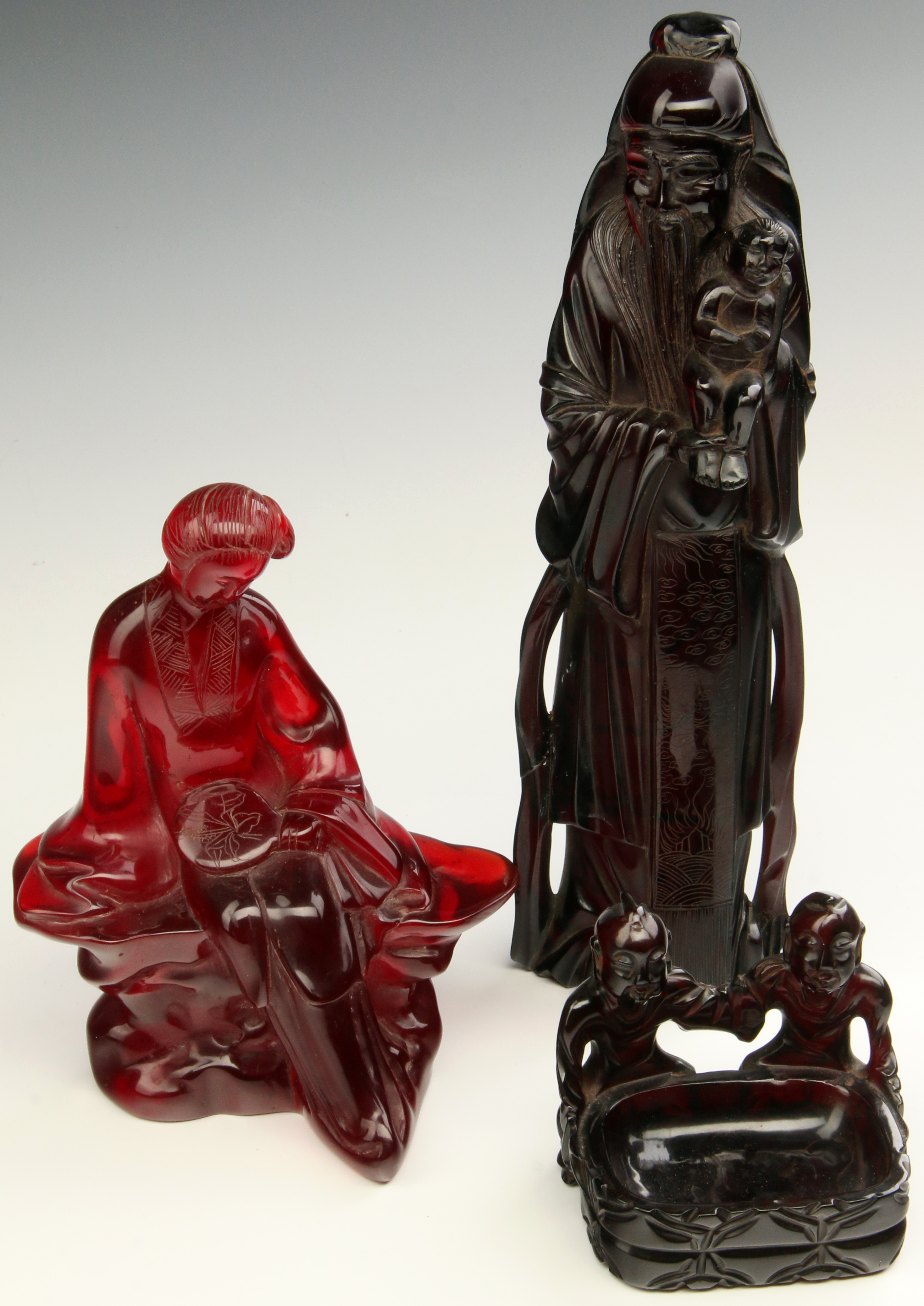 THREE 20TH C. CHINESE CARVED AMBER FIGURES