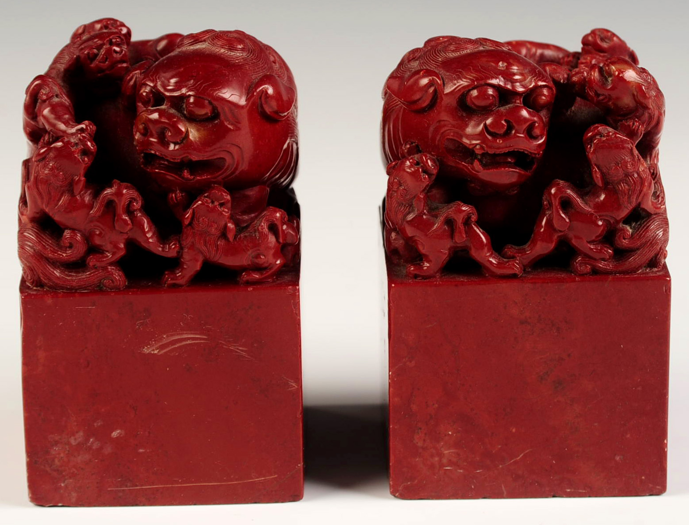 A PAIR CHINESE CARVED BLOOD STONE FU DOGS