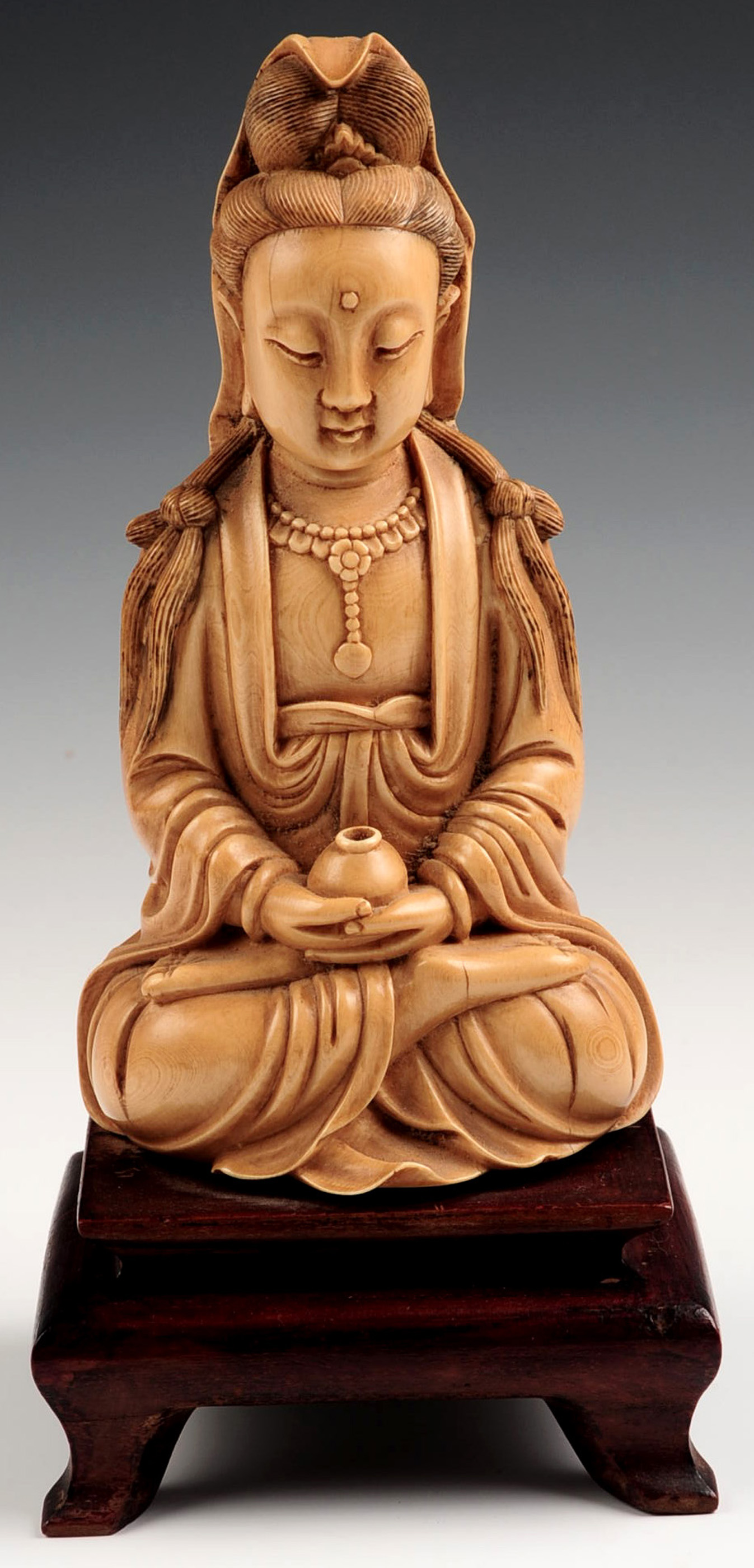 A 19TH C. CHINESE CARVED IVORY STATUE OF SEATED GU