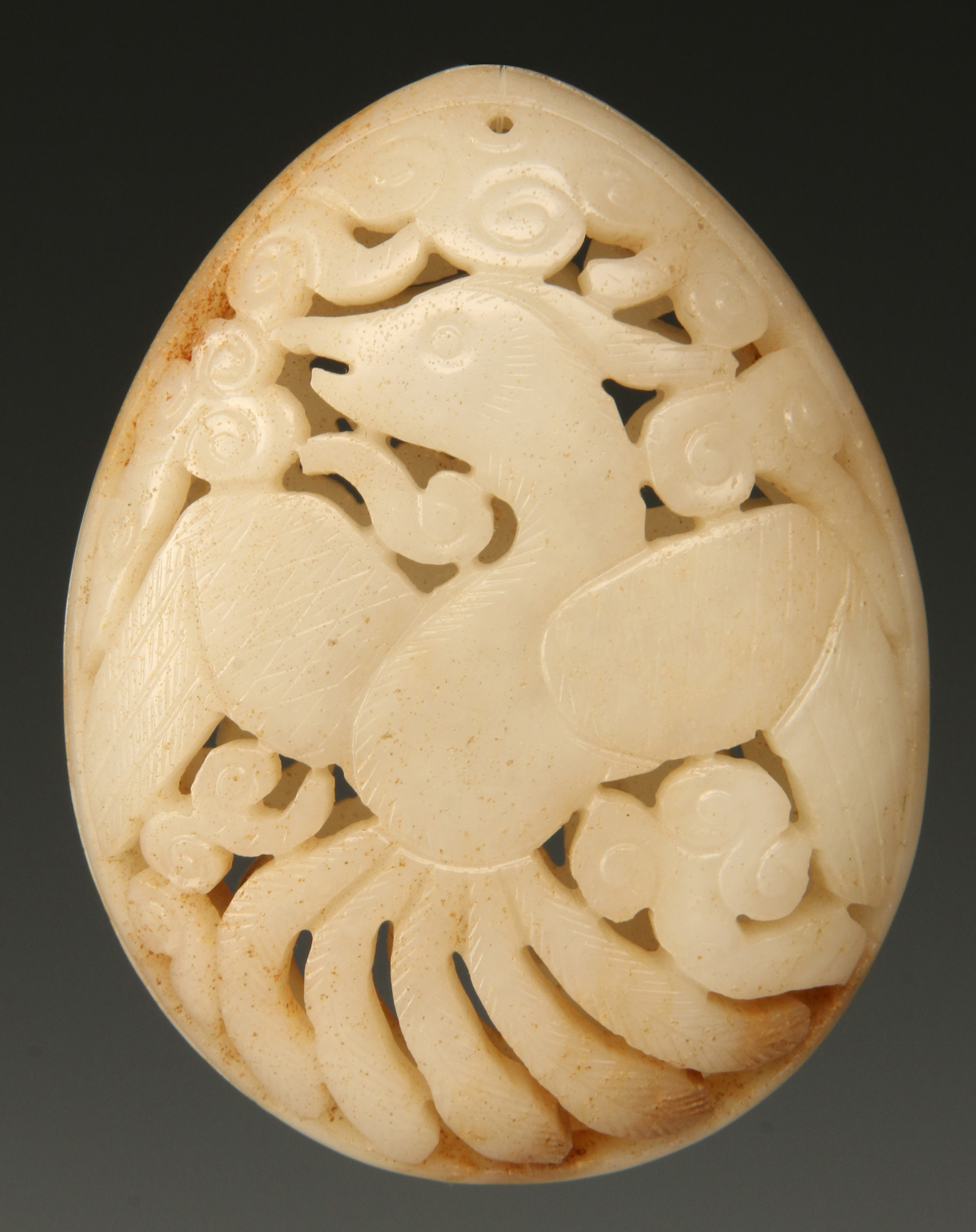 A CHINESE CARVED AND PIERCED HARDSTONE PENDANT