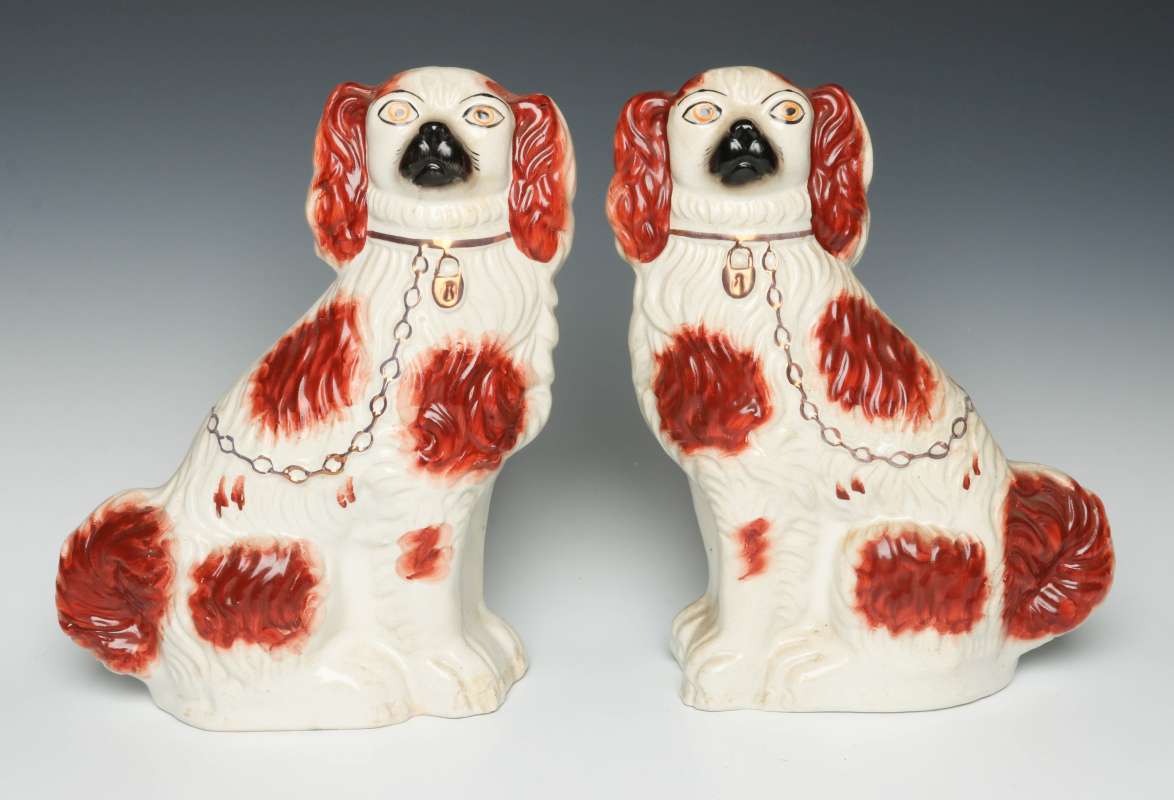 A PAIR OF 19TH CENT STAFFORDSHIRE POTTERY SPANIELS