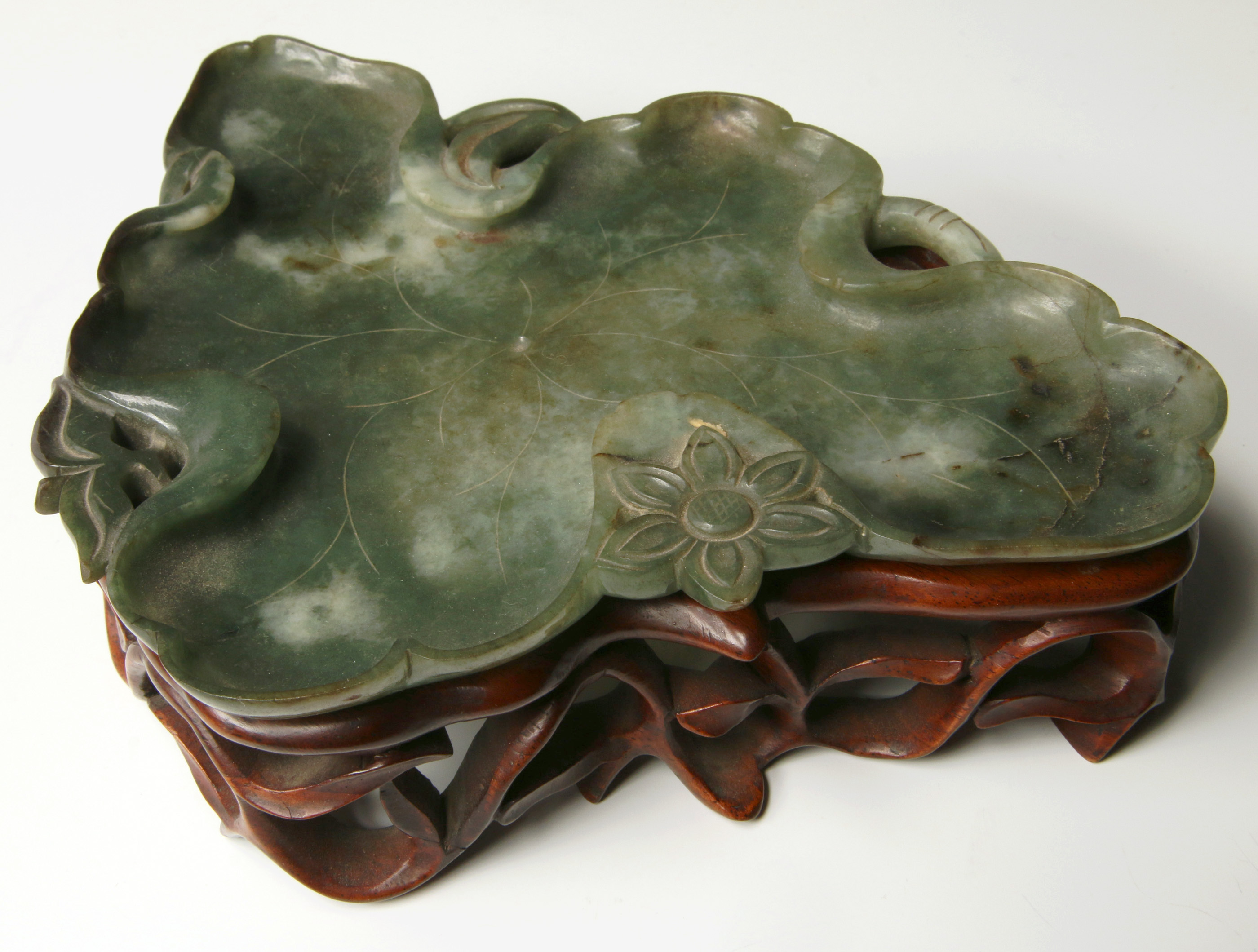 A CHINESE JADE BRUSH WASHER ON CARVED WOOD STAND