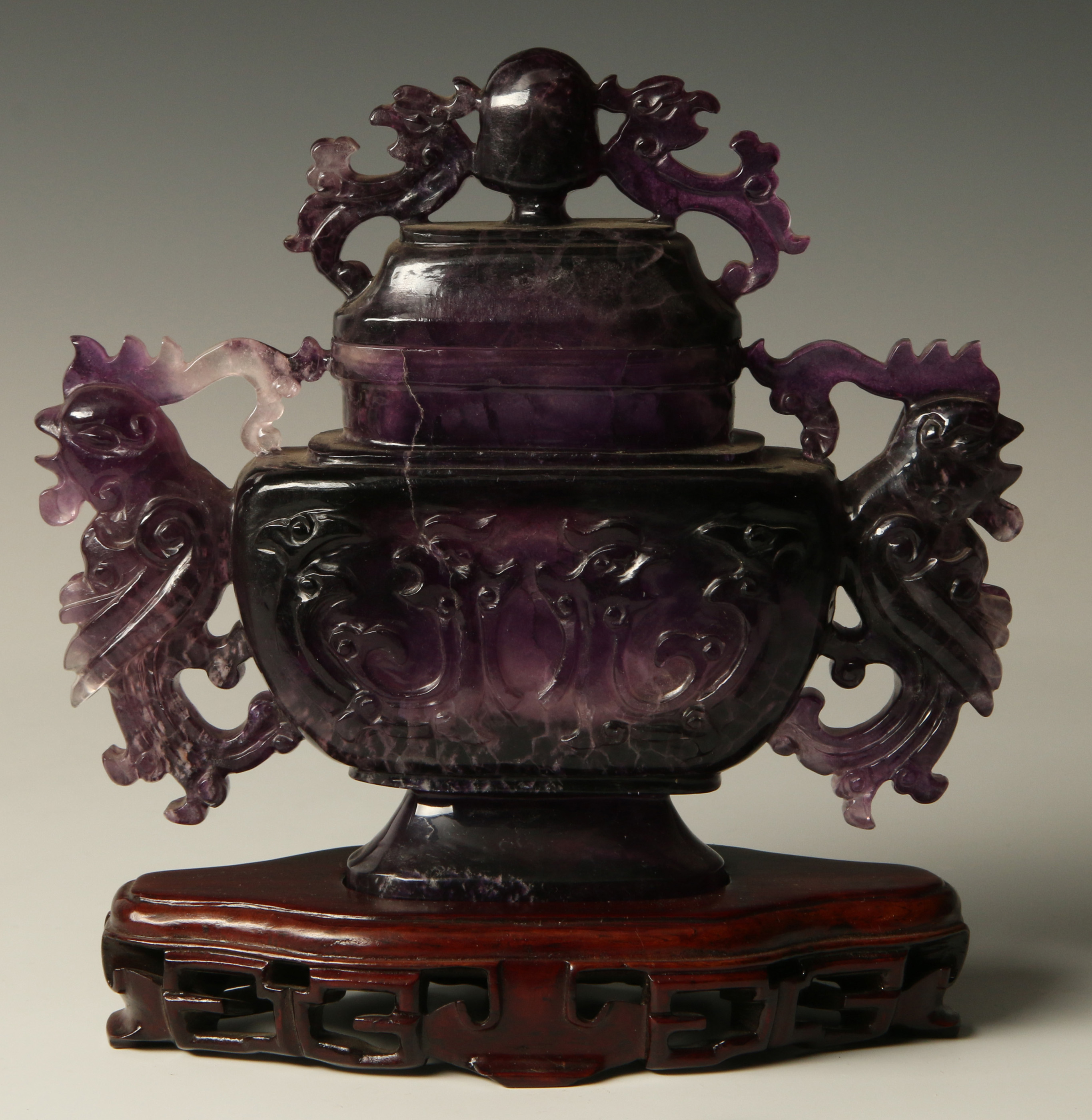 A CHINESE CARVED AMETHYST CENSOR ON STAND
