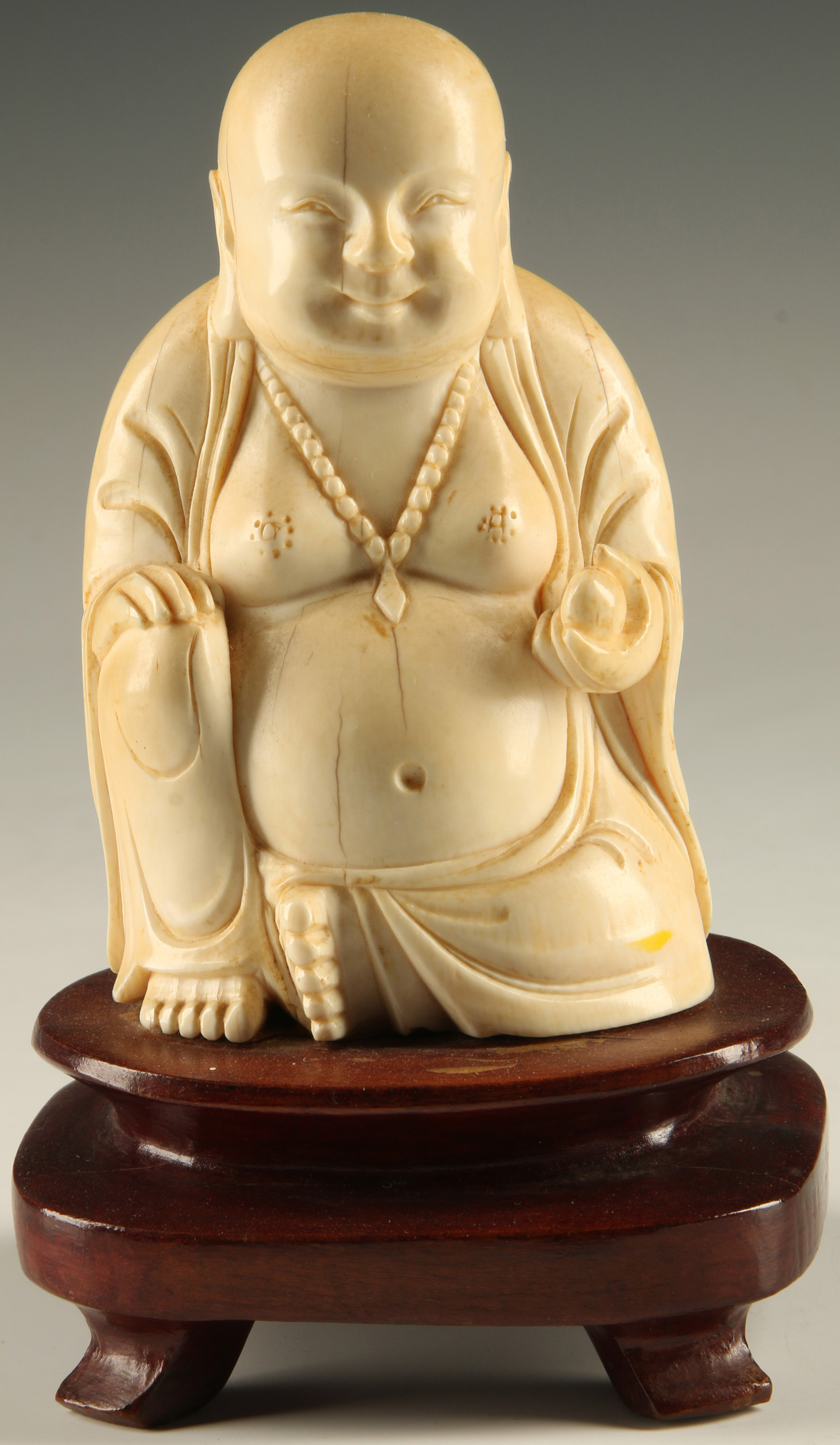 A MID 20TH CENTURY CARVED IVORY FIGURE OF BUDDHA