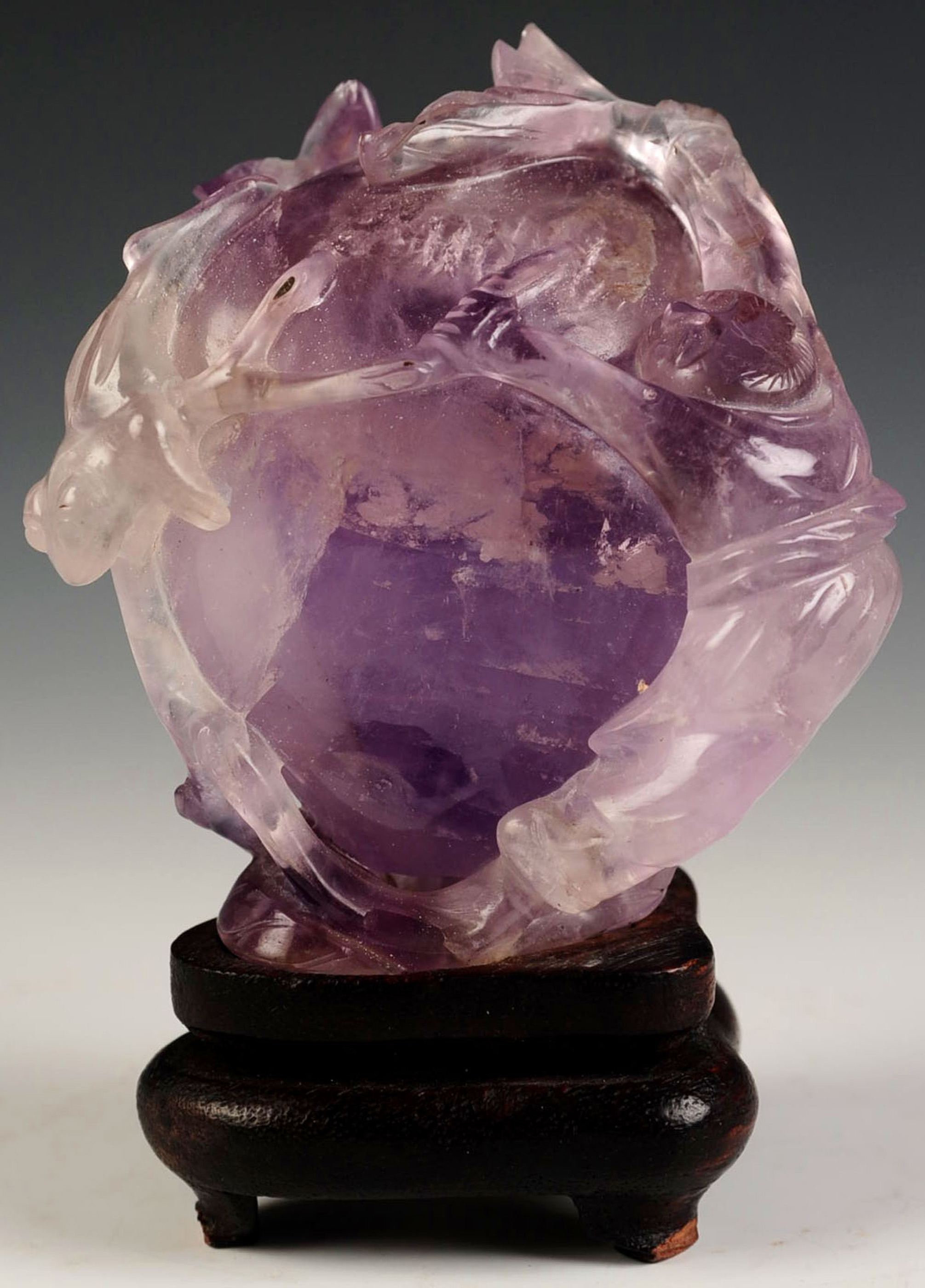 A CHINESE CARVED AMETHYST FRUIT