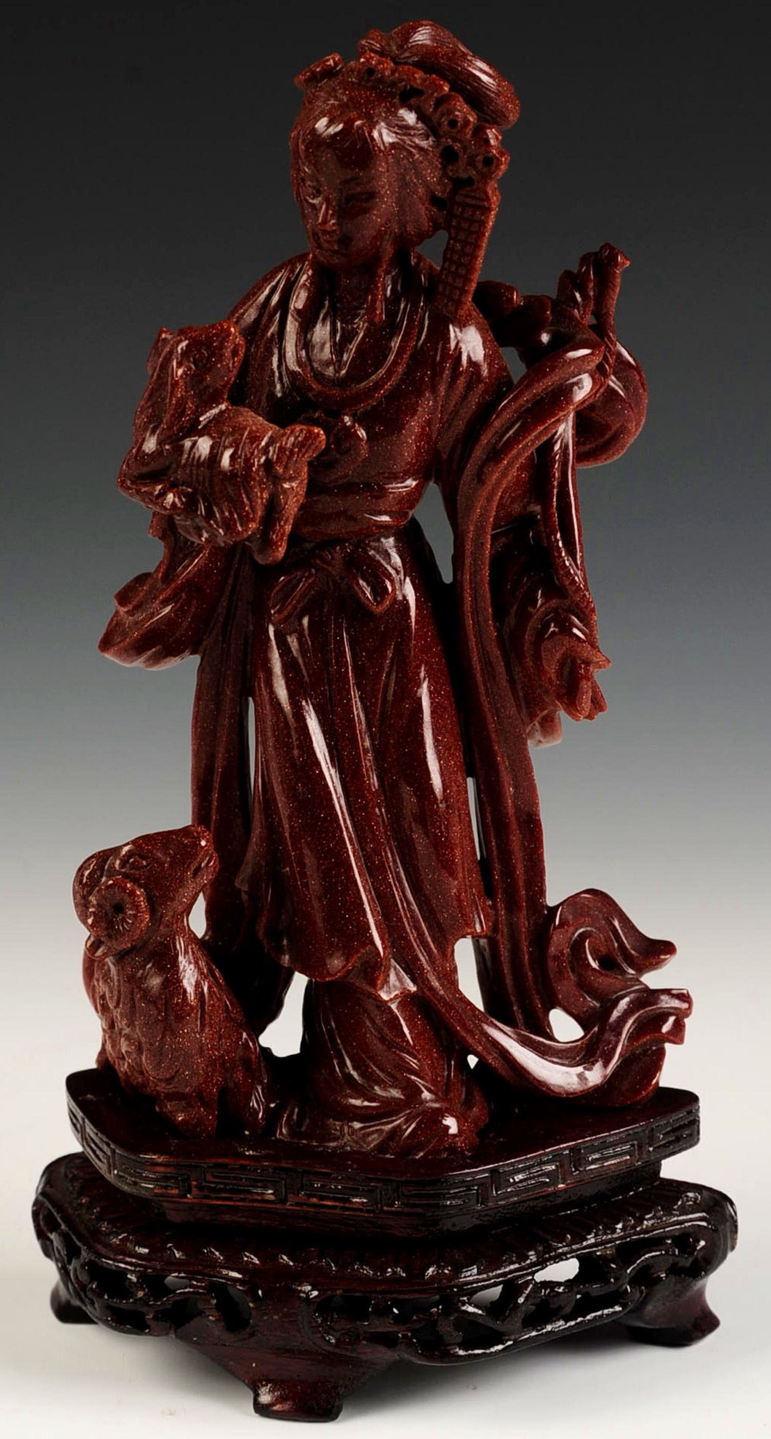A CHINESE CARVED GOLDSTONE FIGURINE