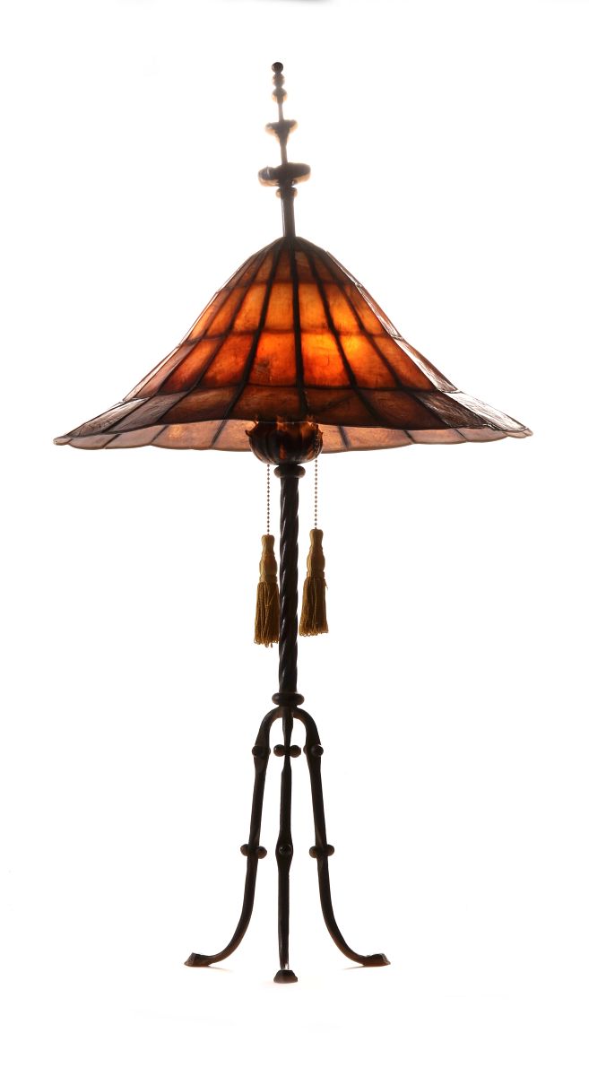A WROUGHT AND CAST IRON LAMP WITH MICA SHADE