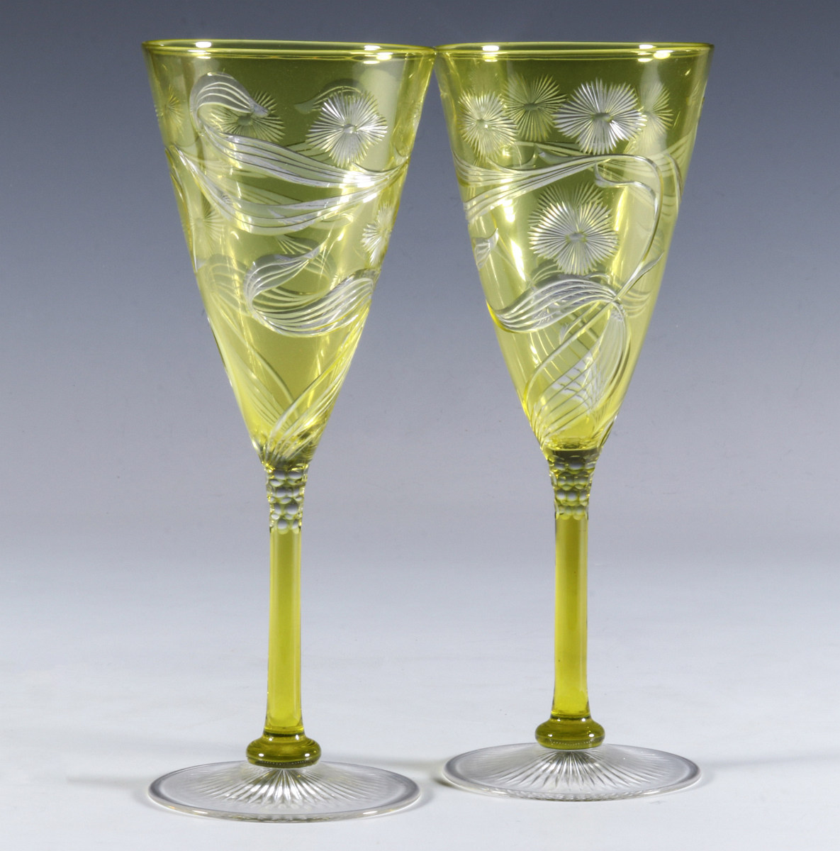A FINE PAIR OF CITRON GREEN CUT TO CLEAR GOBLETS