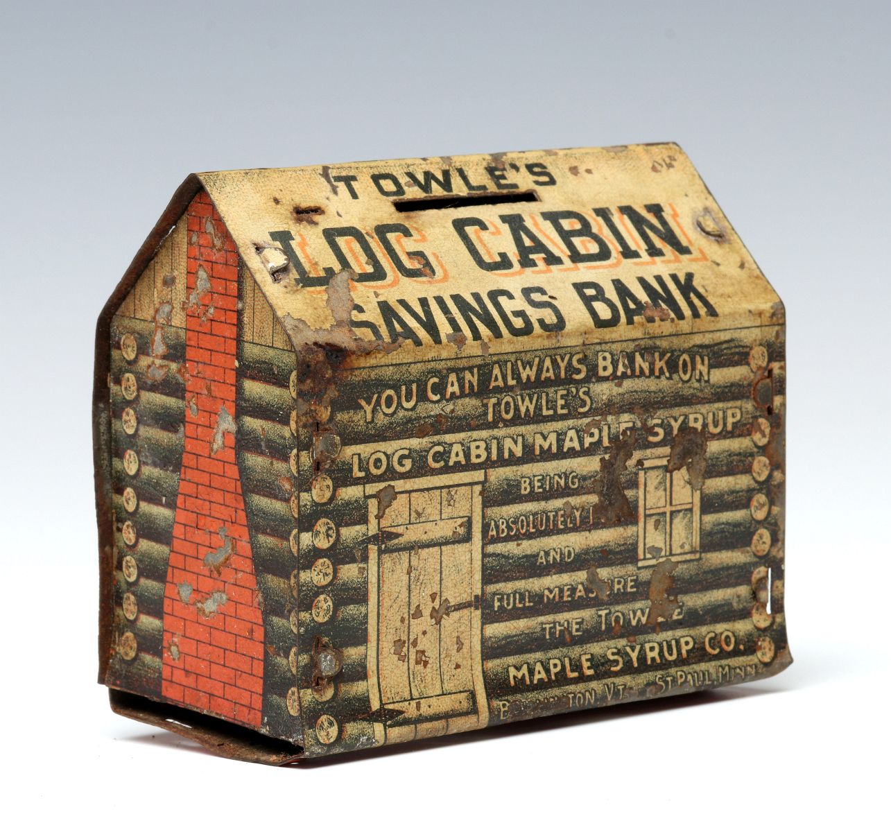 A RARE EARLY TIN LITHO TOWLE'S LOG CABIN COIN BANK