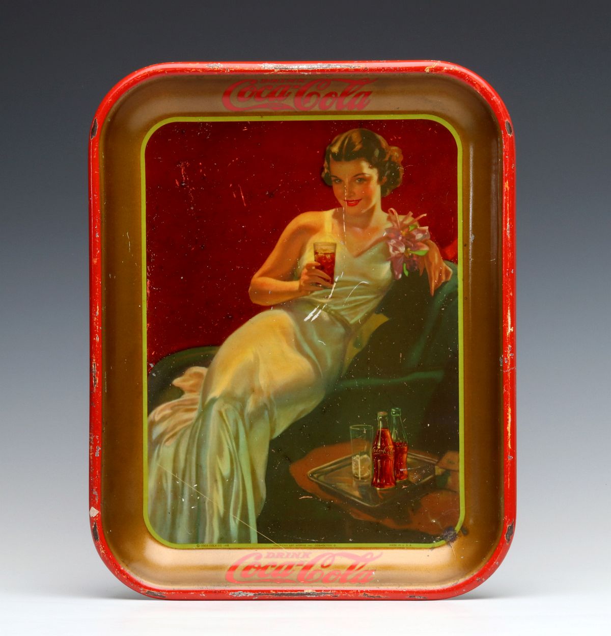 A 1936 COCA-COLA SERVING TRAY WITH WOMAN IN GOWN