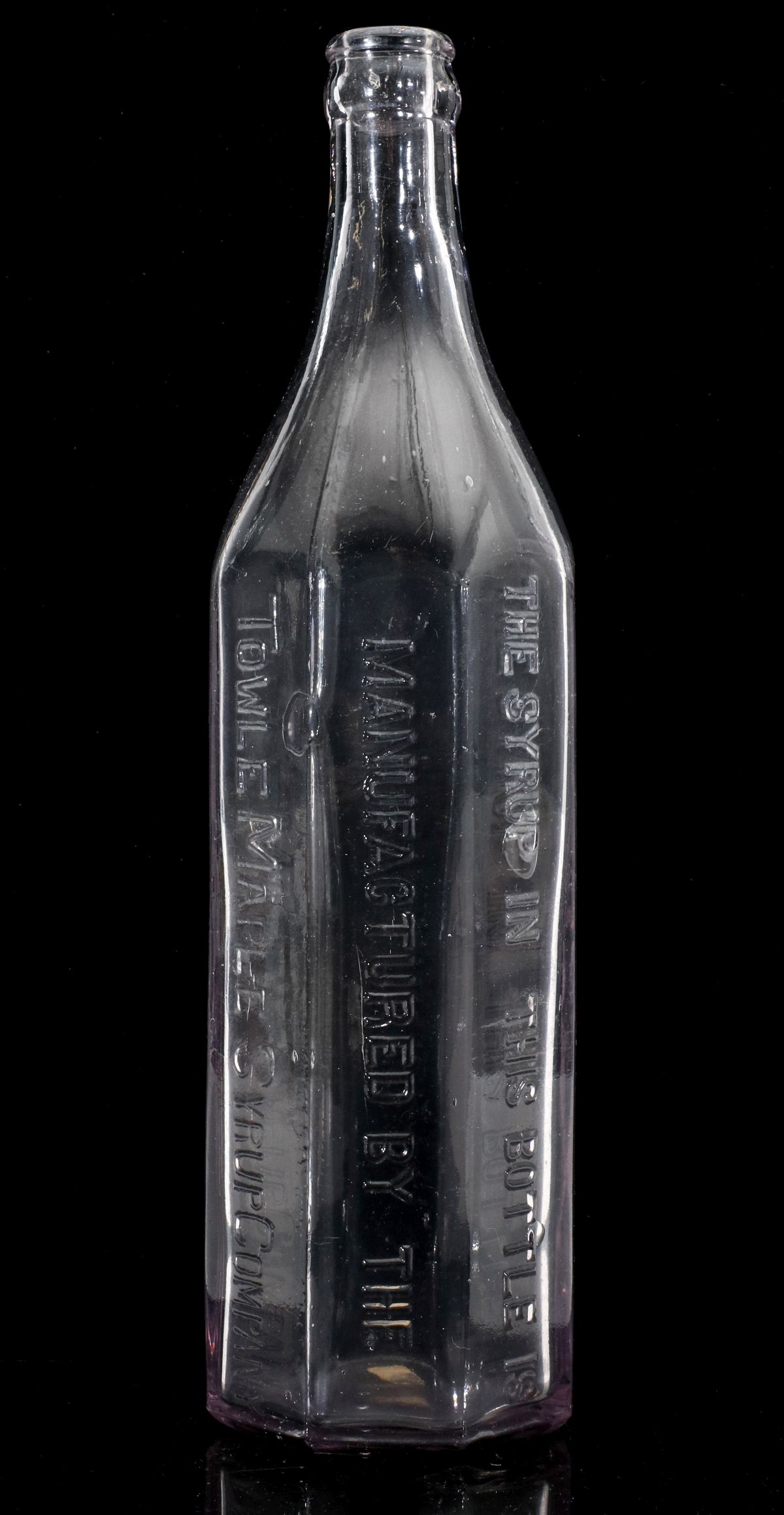 AN EARLY EIGHT-SIDED LOG CABIN SYRUP BOTTLE