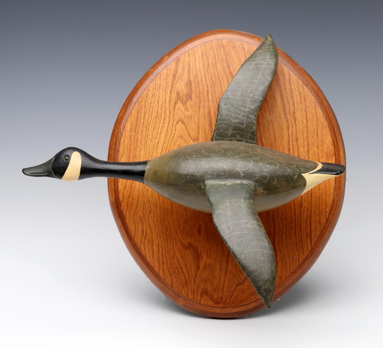 A VINTAGE HANGING WOOD CARVING OF A CANADIAN GOOSE
