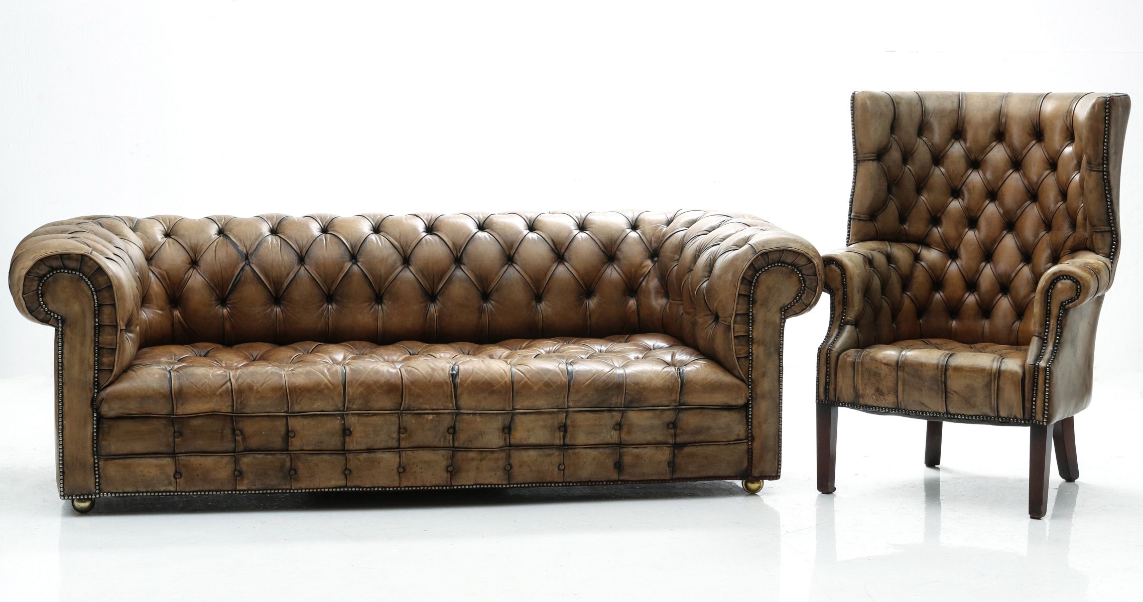 A VINTAGE LEATHER CHESTERFIELD SOFA AND WING BACK