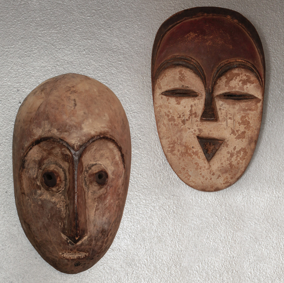 TWO CARVED AND PAINTED AFRICAN MASKS