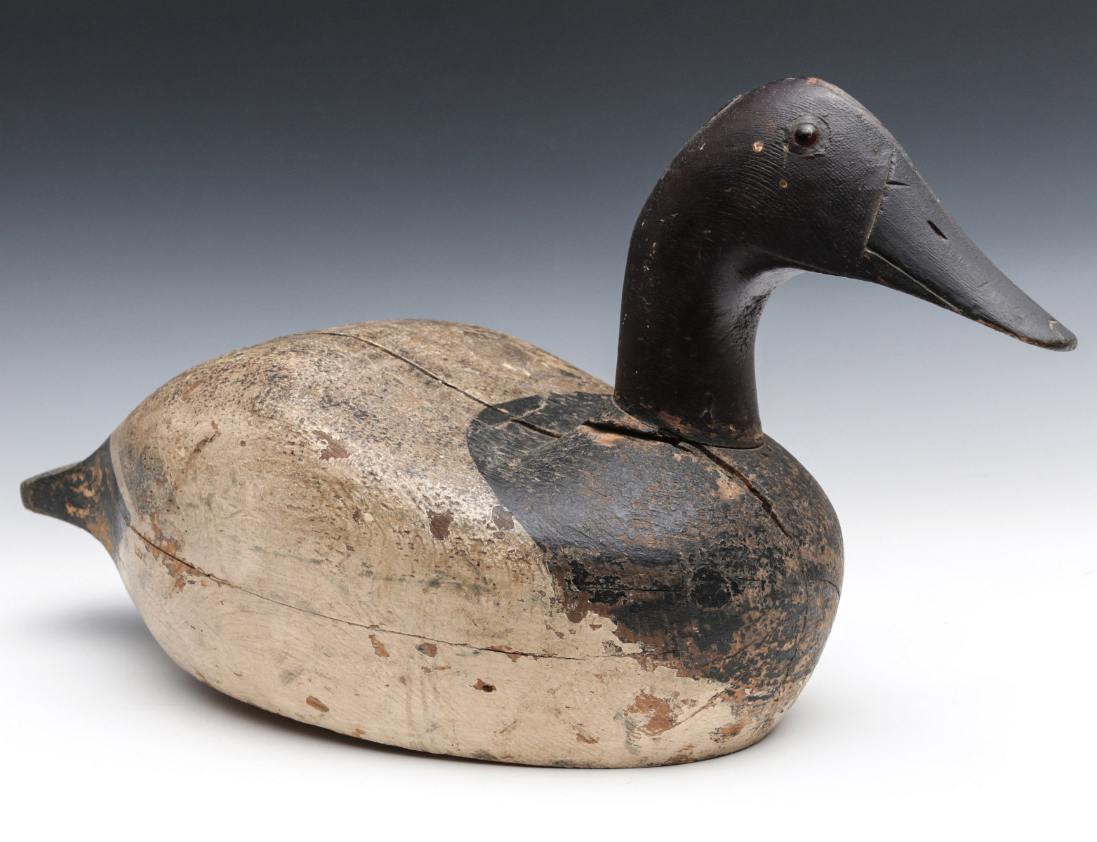 A GOOD EARLY CARVED PANTED CANVASBACK DRAKE DECOY